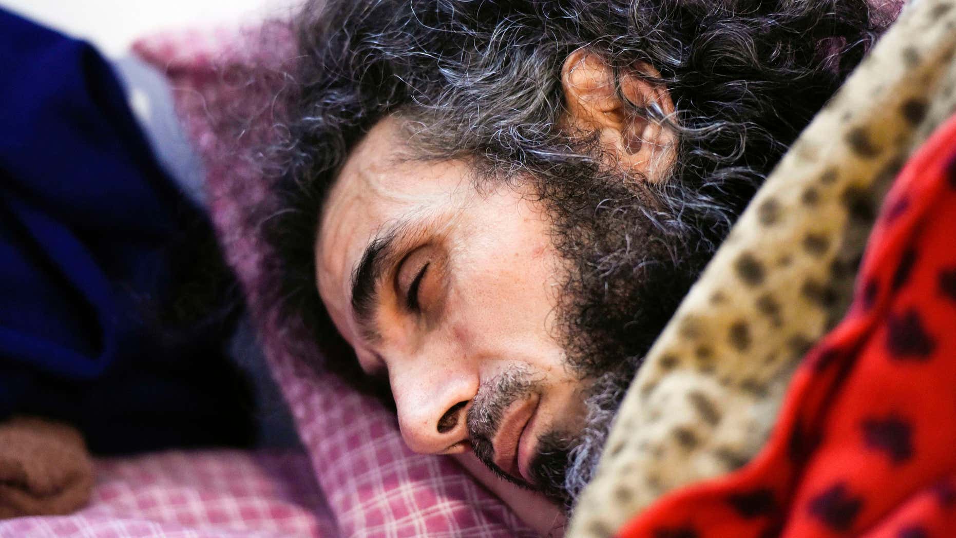 FILE - In this Sept. 9, 2016 file photo, Syrian native Abu Wa'el Dhiab rests in bed while conversing with his family via a laptop, in his apartment in Montevideo, Uruguay.