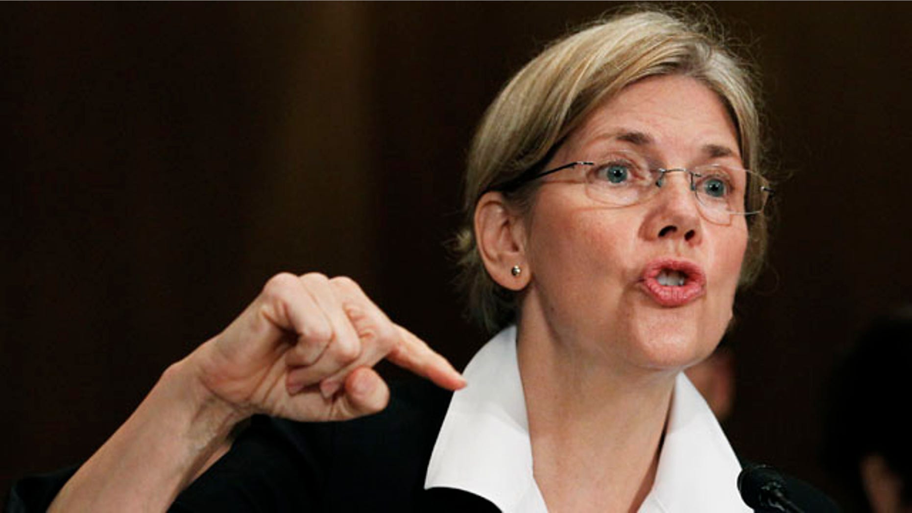 FILE: July 21, 2011: Elizabeth Warren, as head of the Congressional Oversight Panel, testifies before a Senate Finance Committee.