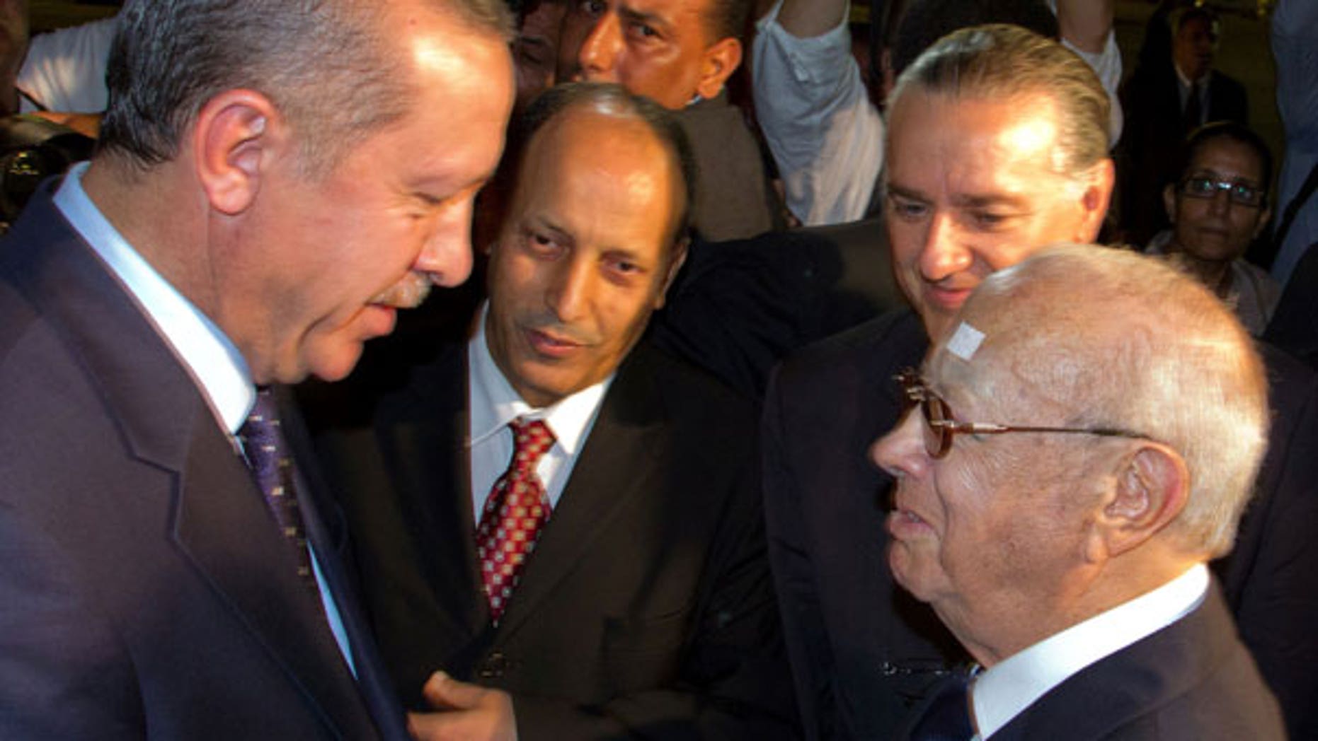 Sept. 14: Tunisian Prime Minister Beji Caid Essebsi, right, greets his Turkish counterpart Recep Tayyip Erdogan , left, at the Tunis-Carthage airport, Tunisia.