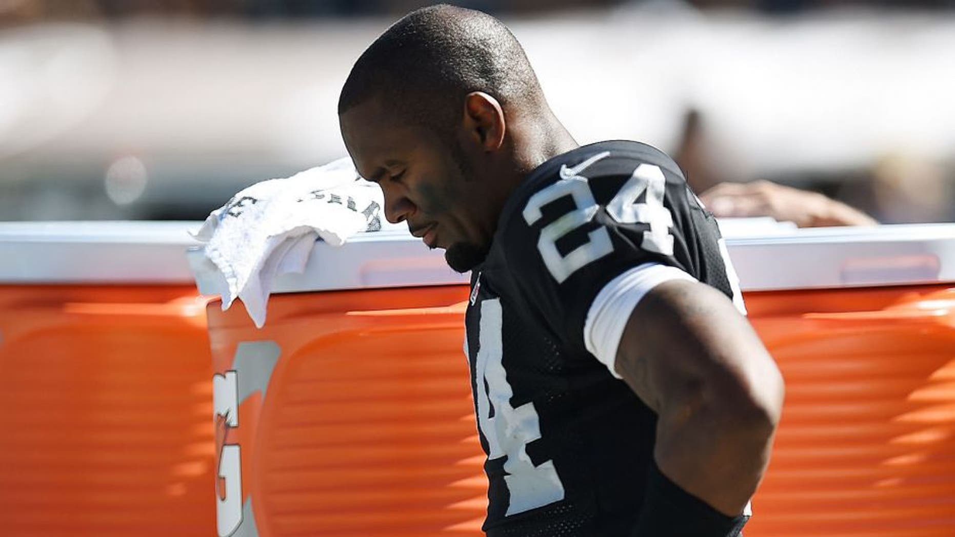 OAKLAND, CA - SEPTEMBER 14: Charles Woodson #24 of the Oakland Raiders leans against a cooler during the third quarter against the Houston Texans at O.co Coliseum on September 14, 2014 in Oakland, California. The Texans won the game 30-14. (Photo by Thearon W. Henderson/Getty Images)