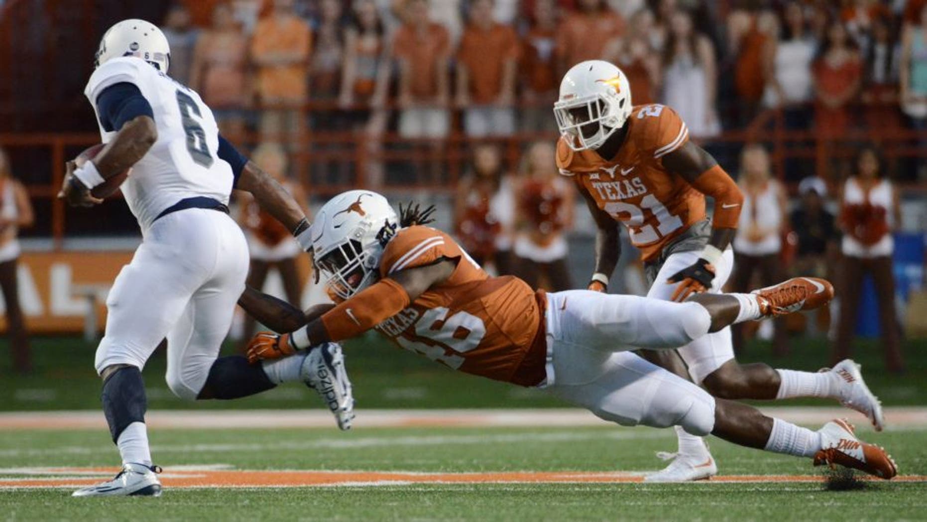 Sep 12, 2015; Austin, TX, USA; Texas Longhorns linebacker Malik Jefferson (46) and corner back Duke Thomas (21) pressure Rice Owls quarterback Driphus Jackson (6) during the first quarter at Darrell K Royal-Texas Memorial Stadium. Mandatory Credit: Brendan Maloney-USA TODAY Sports