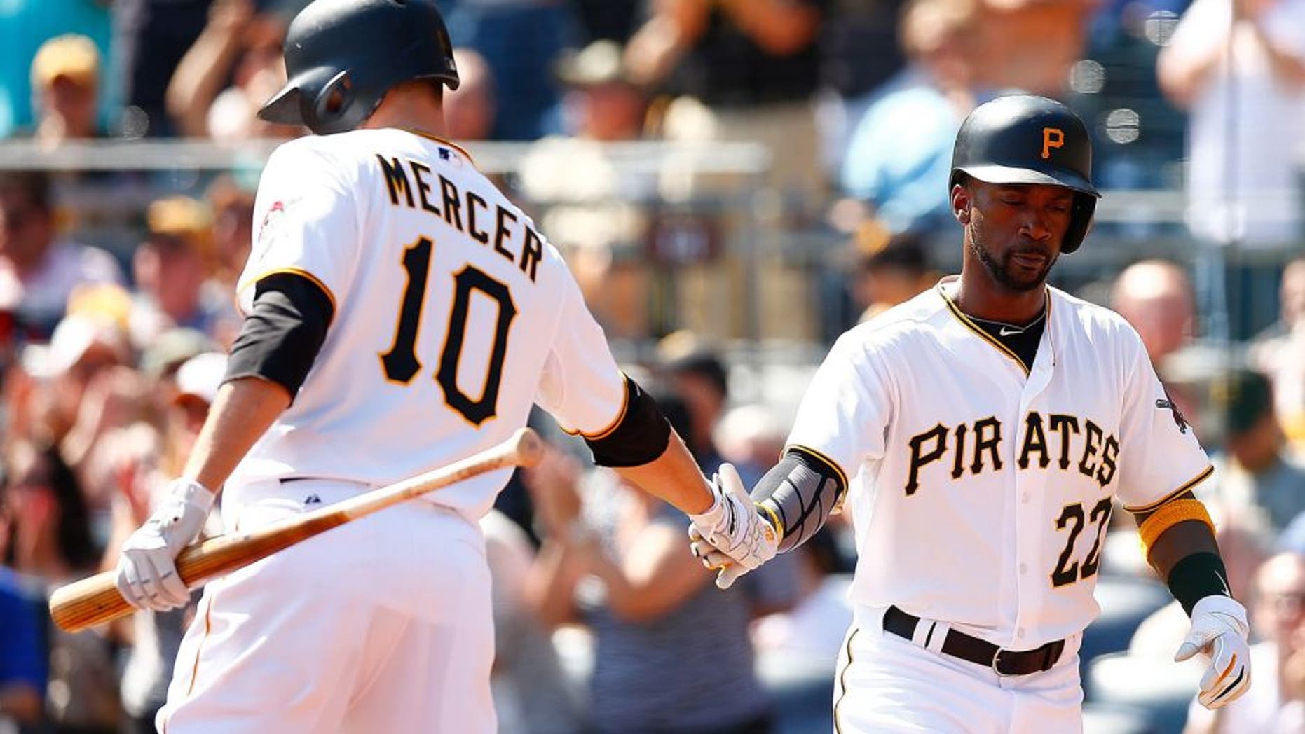 PITTSBURGH, PA - SEPTEMBER 15: Andrew McCutchen #22 of the Pittsburgh Pirates is congratulated by teammate Jordy Mercer #10 after scoring in the first inning against the Chicago Cubs during game one of the doubleheader at PNC Park on September 15, 2015 in Pittsburgh, Pennsylvania. (Photo by Jared Wickerham/Getty Images)