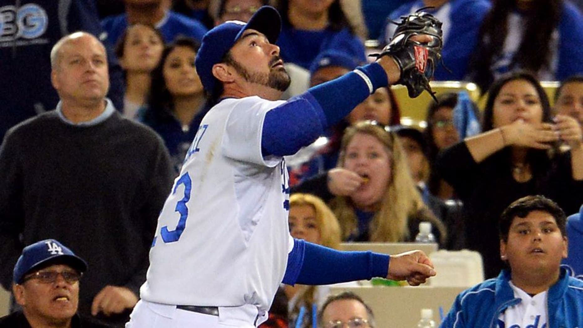 May 23, 2015; Los Angeles, CA, USA; Los Angeles Dodgers first baseman Adrian Gonzalez (23) makes a play on a foul ball in the ninth inning of the game against the San Diego Padres at Dodger Stadium. Dodgers won 2-0. Mandatory Credit: Jayne Kamin-Oncea-USA TODAY Sports