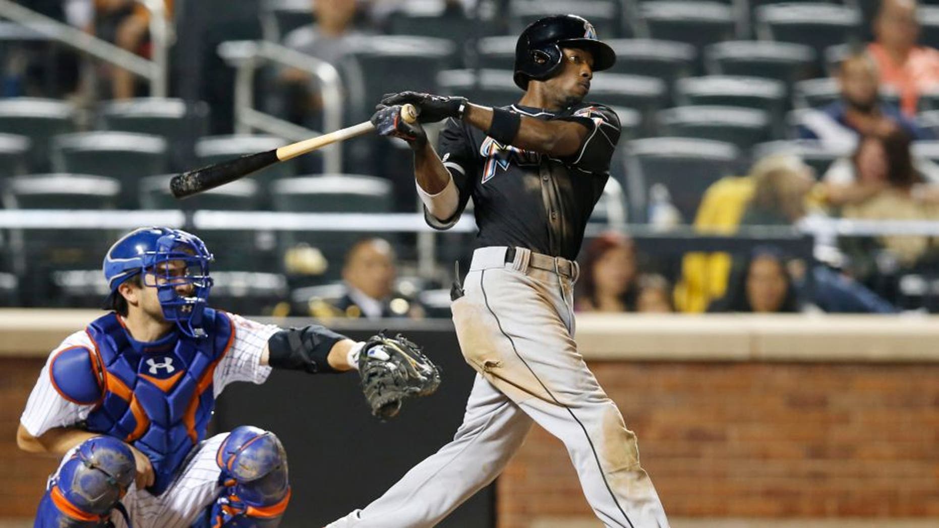 Miami Marlins' Dee Gordon hits a ninth-inning, two-run home run off New York Mets relief pitcher Dario Alvarez during a baseball game in New York, Tuesday, Sept. 15, 2015. (AP Photo/Kathy Willens)