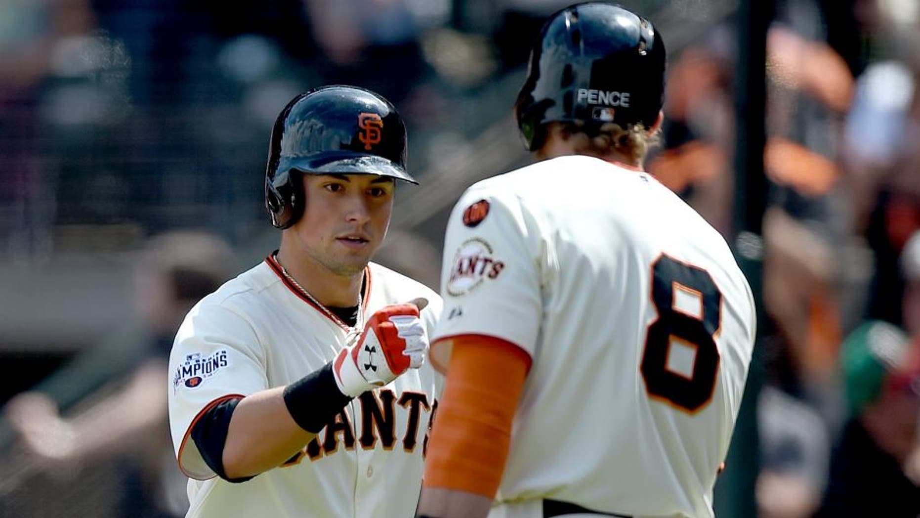 SAN FRANCISCO, CA - MAY 31: Joe Panik #12 of the San Francisco Giants is congratulated by Hunter Pence #8 after Panik hit a two-run homer against the Atlanta Braves in the bottom of the seventh inning at AT&T Park on May 31, 2015 in San Francisco, California. (Photo by Thearon W. Henderson/Getty Images)