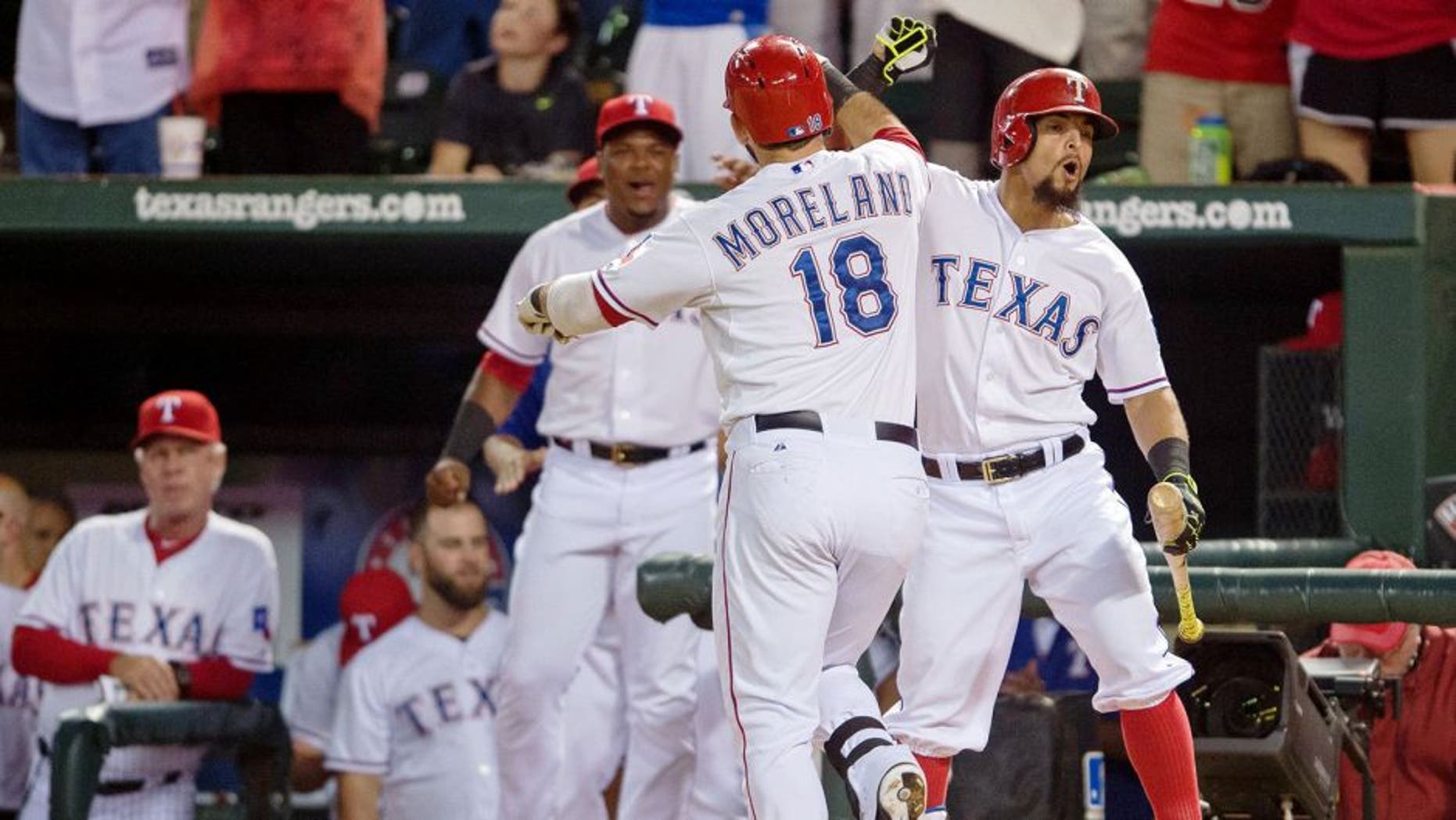 Sep 14, 2015; Arlington, TX, USA; Texas Rangers second baseman Rougned Odor (right) congratulates first baseman Mitch Moreland (18) for hitting a two run home run during the sixth inning against the Houston Astros at Globe Life Park in Arlington. Mandatory Credit: Jerome Miron-USA TODAY Sports