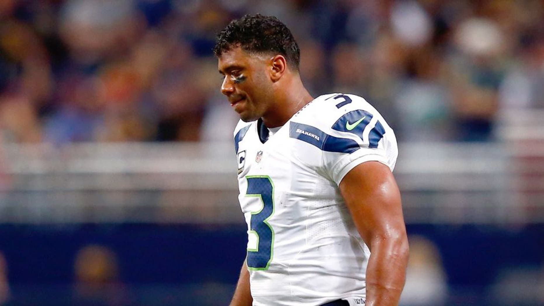 ST LOUIS, MO - SEPTEMBER 13: Quarterback Russell Wilson #3 of the Seattle Seahawks walks off the field during a timeout in the 2nd half of the game against the St. Louis Rams at Edward Jones Dome on September 13, 2015 in St Louis, Missouri. (Photo by Jamie Squire/Getty Images)