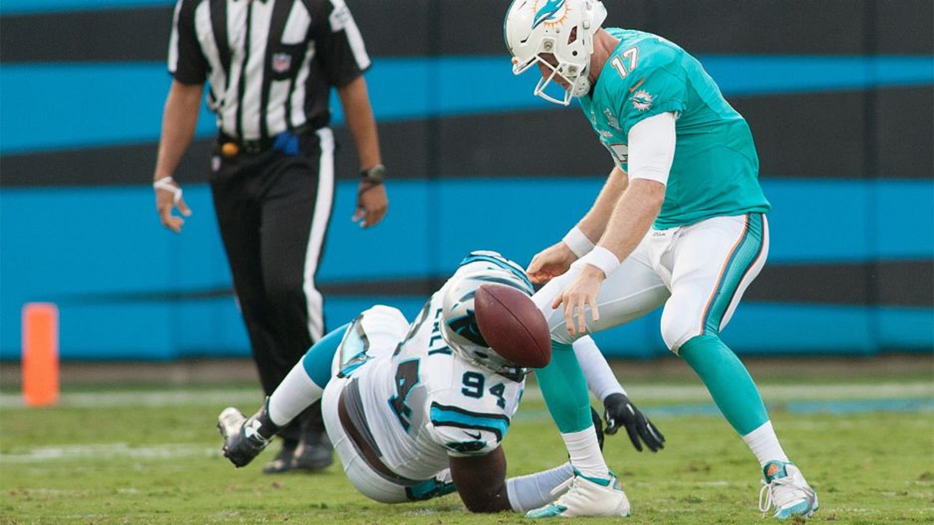 Aug 22, 2015; Charlotte, NC, USA; Carolina Panthers defensive end Kony Ealy (94) knocks the ball loose from Miami Dolphins quarterback Ryan Tannehill (17) during the first quarter at Bank of America Stadium. Mandatory Credit: Jeremy Brevard-USA TODAY Sports