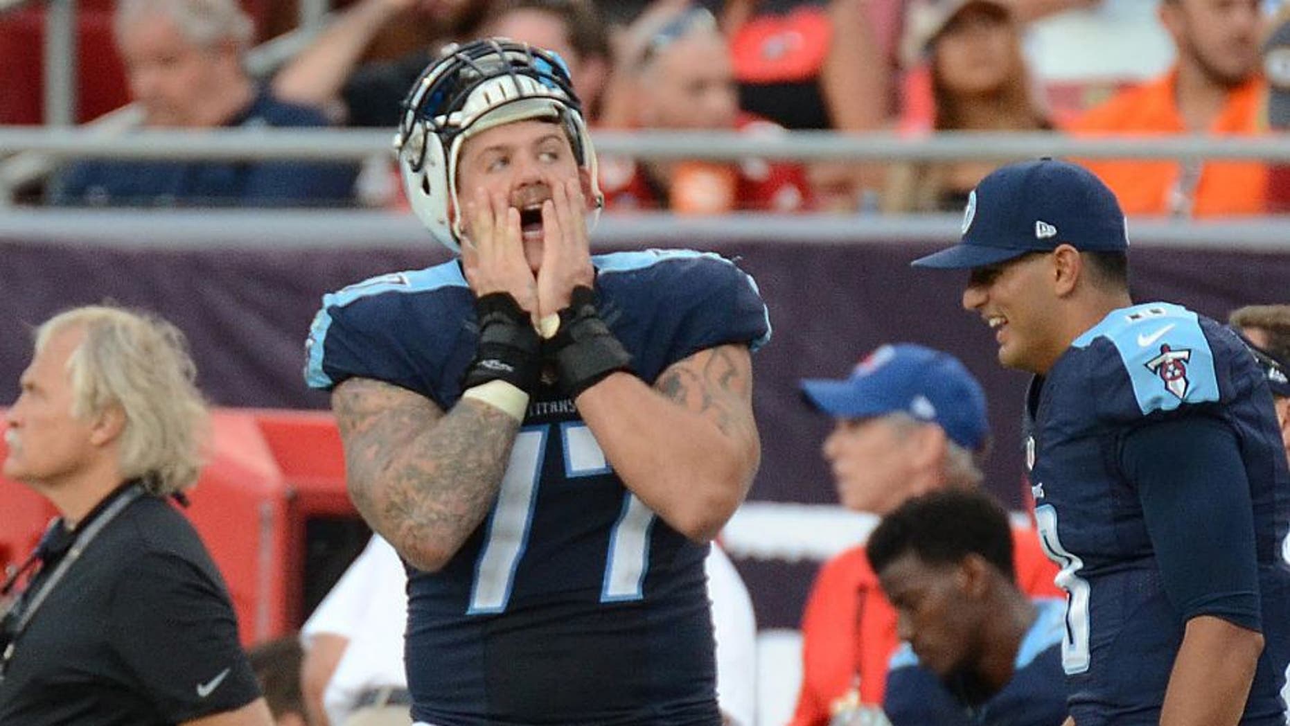 Sep 13, 2015; Tampa, FL, USA; Tennessee Titans quarterback Marcus Mariota (8) and linemen Taylor Lewan (77) react on the sideline in the second half during their game against the Tampa Bay Buccaneers at Raymond James Stadium. The Titans defeated the Buccaneers 42-14. Mandatory Credit: Jonathan Dyer-USA TODAY Sports