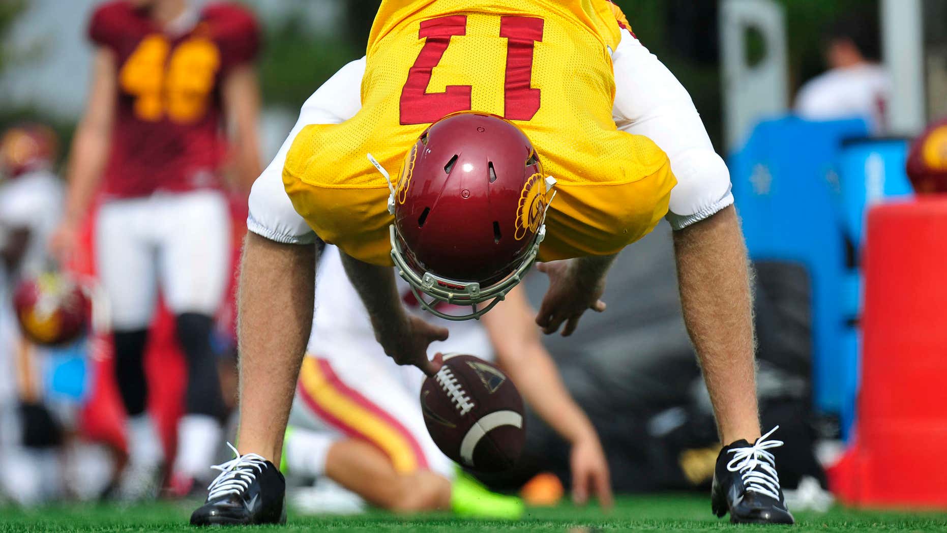 Sept. 15, 2015: This photo provided by the University of Southern California shows USC football player Jake Olson snaping the ball during NCAA college football practice on in Los Angeles.