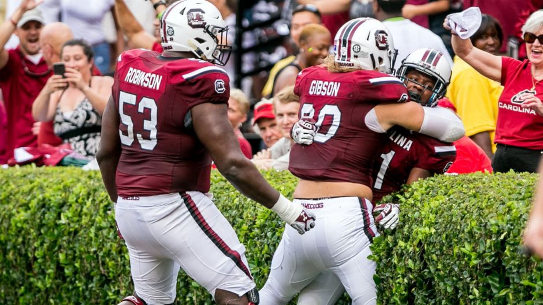 Sep 13, 2014; Columbia, SC, USA; South Carolina Gamecocks offensive tackle Corey Robinson (53) and tight end Cody Gibson (90) and wide receiver Pharoh Cooper (11) celebrate a touchdown by Cooper against the Georgia Bulldogs in the first quarter at Williams-Brice Stadium. Mandatory Credit: Jeff Blake-USA TODAY Sports