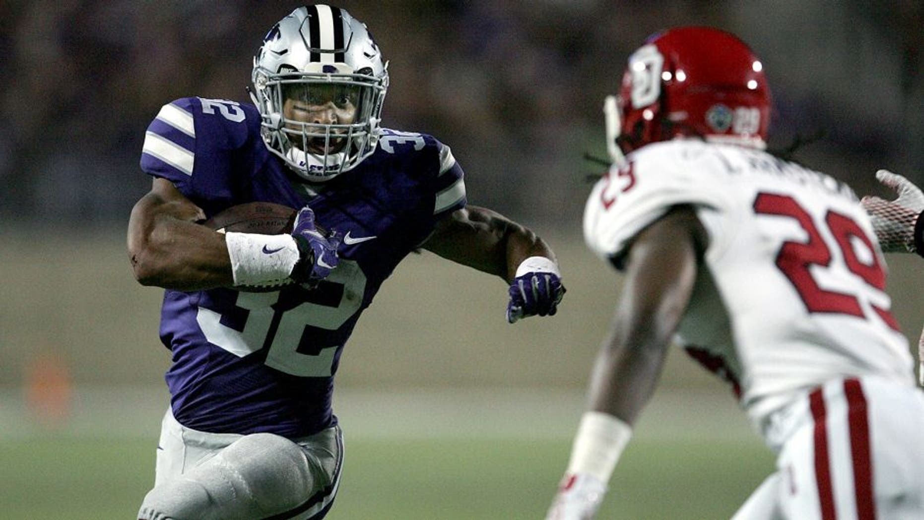 Sep 5, 2015; Manhattan, KS, USA; Kansas State Wildcats running back Justin Silmon (32) looks for room to run against South Dakota Coyotes defensive back Isaac Armstead (29) during the Wildcats' 34-0 win at Bill Snyder Family Football Stadium. Mandatory Credit: Scott Sewell-USA TODAY Sports