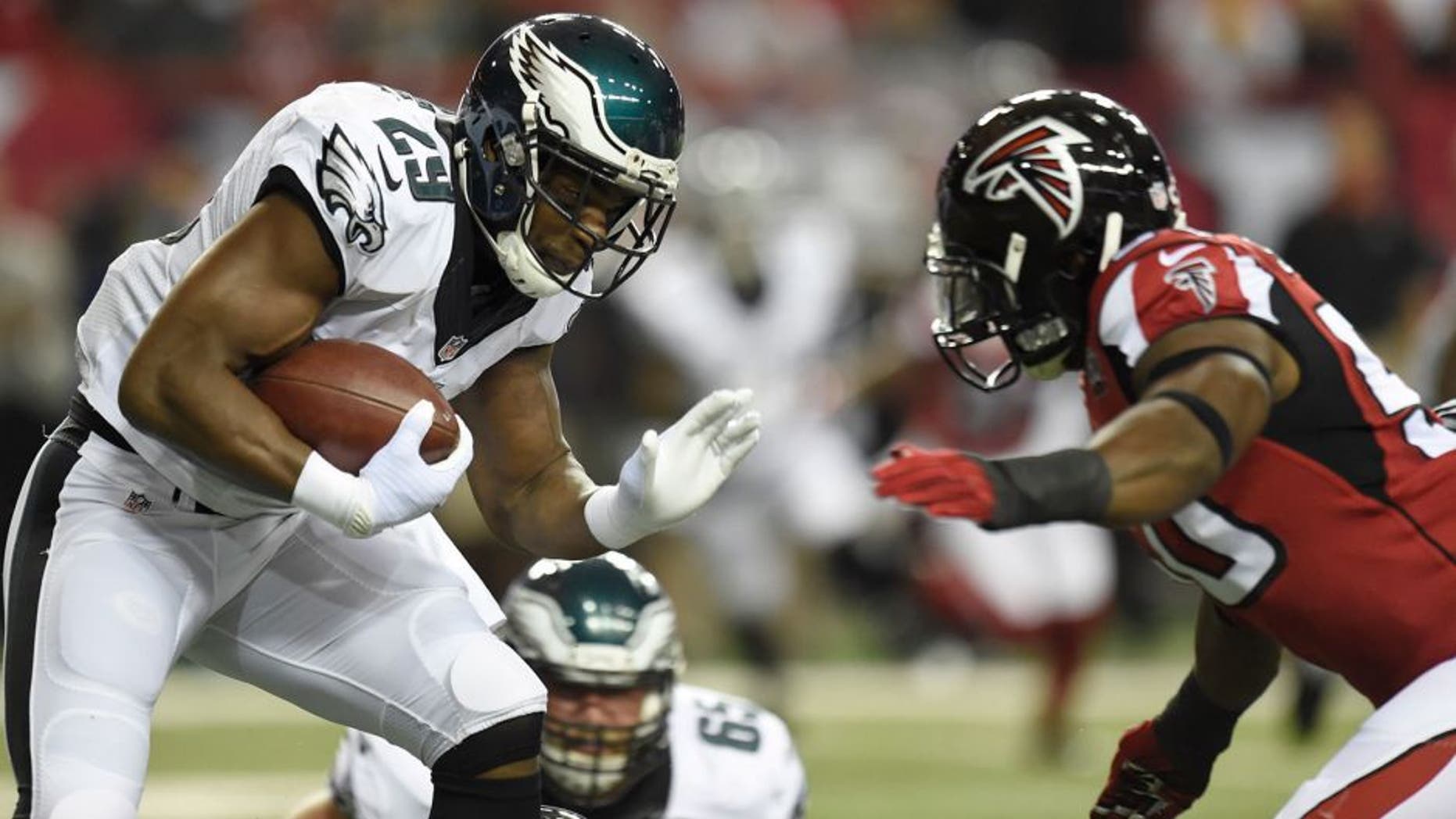 Sep 14, 2015; Atlanta, GA, USA; Philadelphia Eagles running back DeMarco Murray (29) carries the ball as he is chased by Atlanta Falcons linebacker O'Brien Schofield (50) in the first quarter at the Georgia Dome. Mandatory Credit: Dale Zanine-USA TODAY Sports