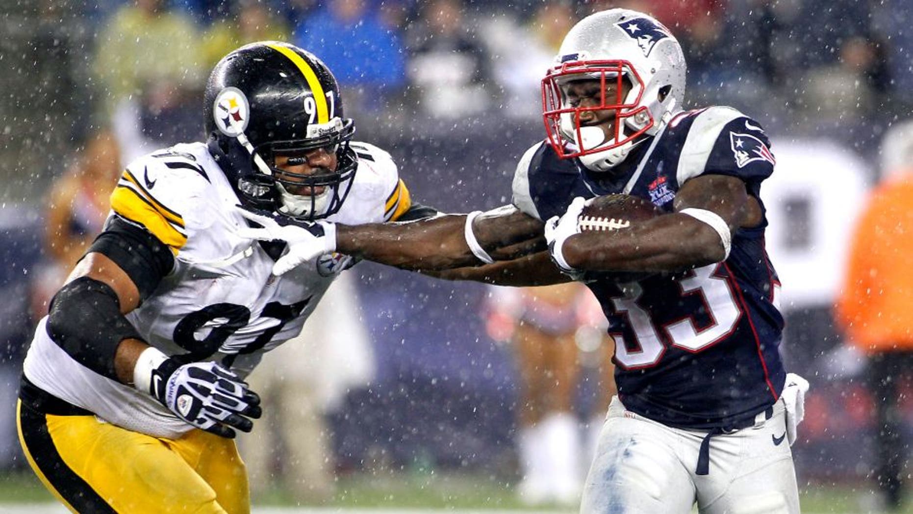 Sep 10, 2015; Foxborough, MA, USA; Pittsburgh Steelers defensive end Cameron Heyward (97) attempts to tackle New England Patriots running back Dion Lewis (33) during the fourth quarter at Gillette Stadium. Mandatory Credit: Stew Milne-USA TODAY Sports