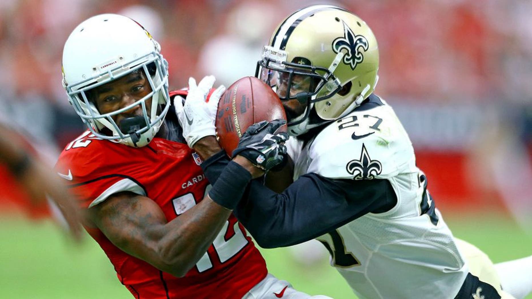 Sep 13, 2015; Glendale, AZ, USA; New Orleans Saints cornerback Damian Swann (right) breaks up a pass intended for Arizona Cardinals wide receiver John Brown in the second quarter at University of Phoenix Stadium. Mandatory Credit: Mark J. Rebilas-USA TODAY Sports