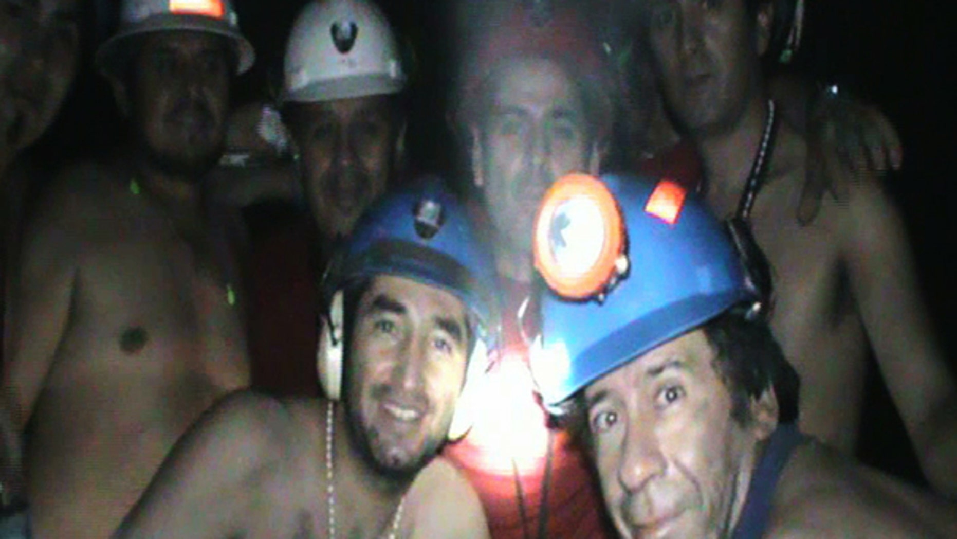 Sept. 17: In this TV grab taken from a video released by Chile's Presidency, trapped miners celebrate inside the San Jose mine in Copiapo, Chile. Drilling equipment pounded its way into one of the caverns where 33 miners have been trapped for a month and a half, completing a bore hole ahead of schedule and raising hopes that the men can be pulled out earlier than expected.