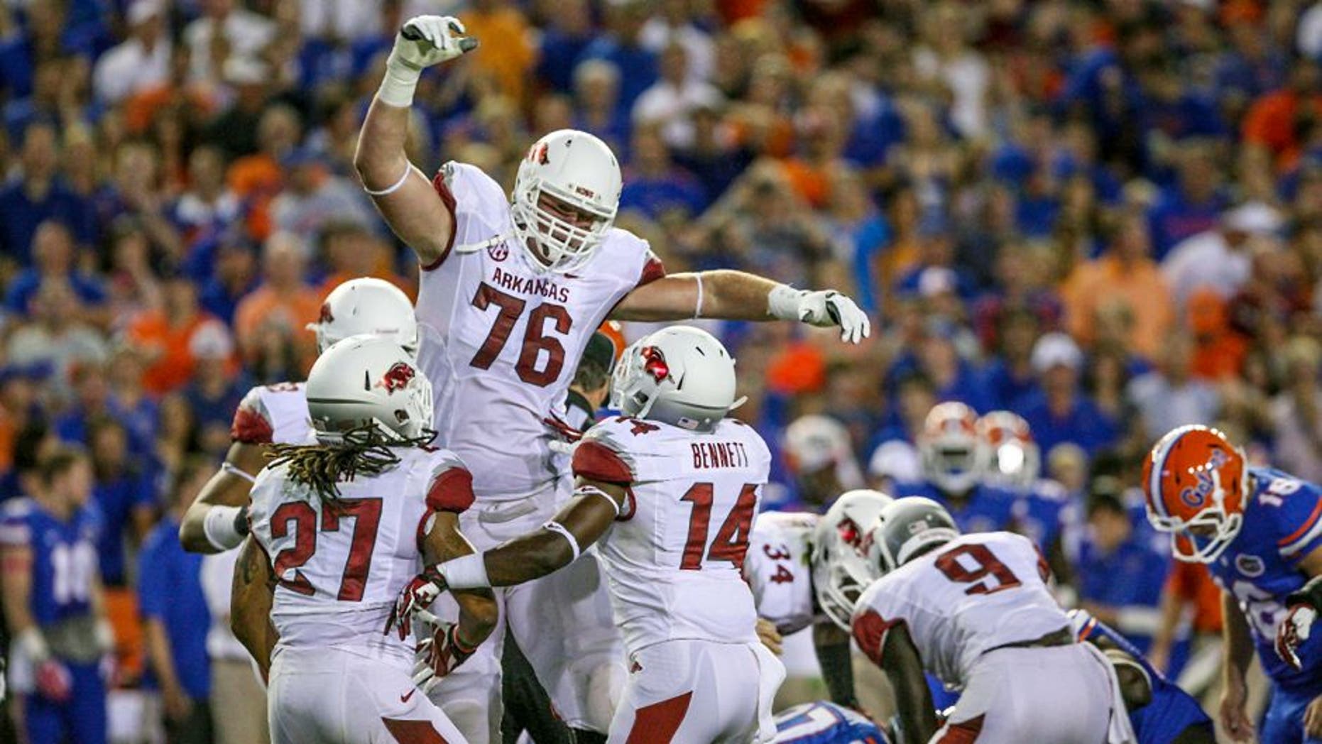 Oct 5, 2013; Gainesville, FL, USA; Arkansas Razorbacks offensive tackle Dan Skipper (76) reacts after blocking a field goal during the first half of the game against the Florida Gators at Ben Hill Griffin Stadium. Mandatory Credit: Rob Foldy-USA TODAY Sports