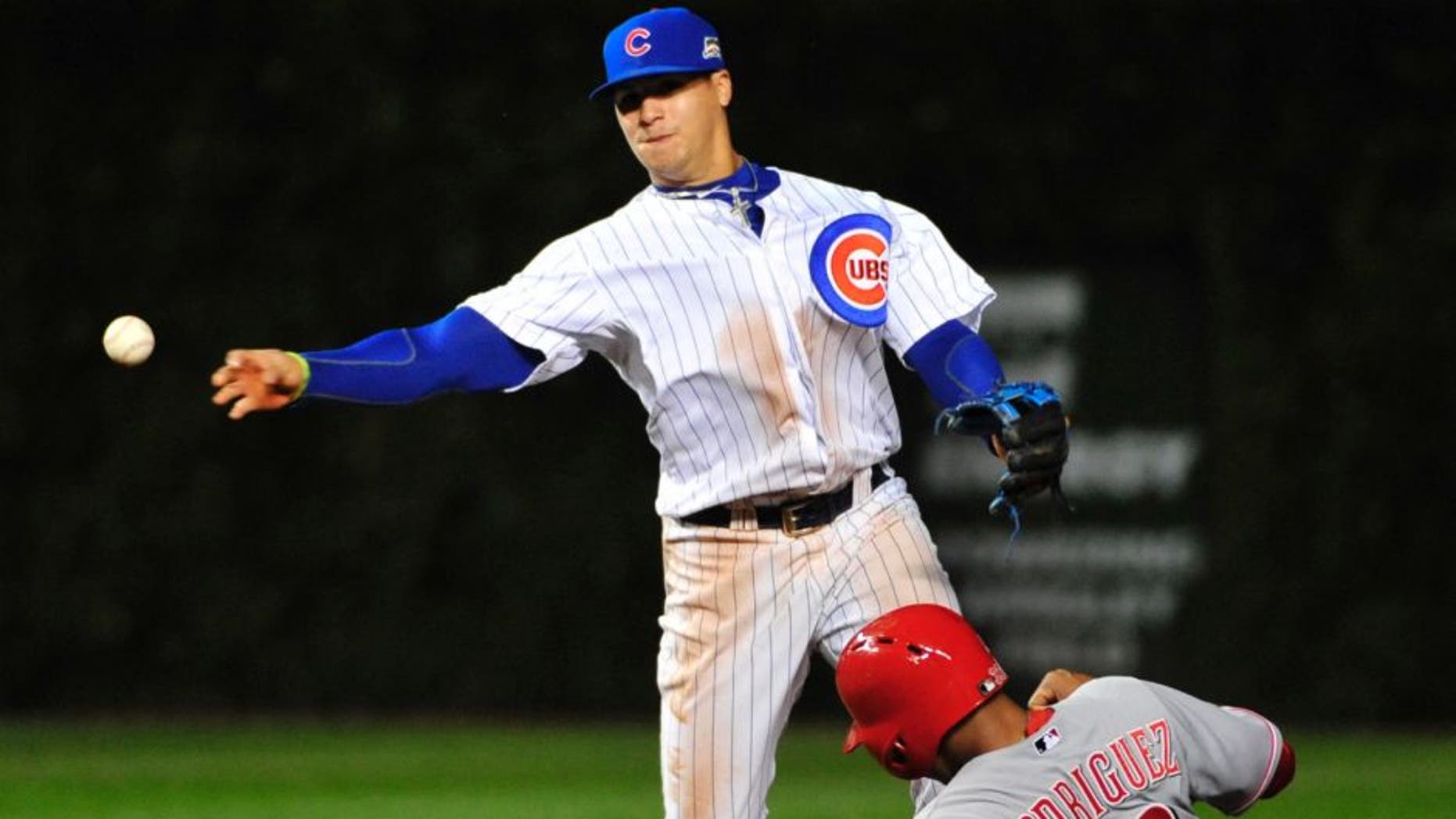 Chicago Cubs shortstop Javier Baez, left, forces out Cincinnati Reds' Yorman Rodriguez (33) at second base during the fourth inning of a baseball game, Wednesday, Sept. 17, 2014 in Chicago. (AP Photo/David Banks)