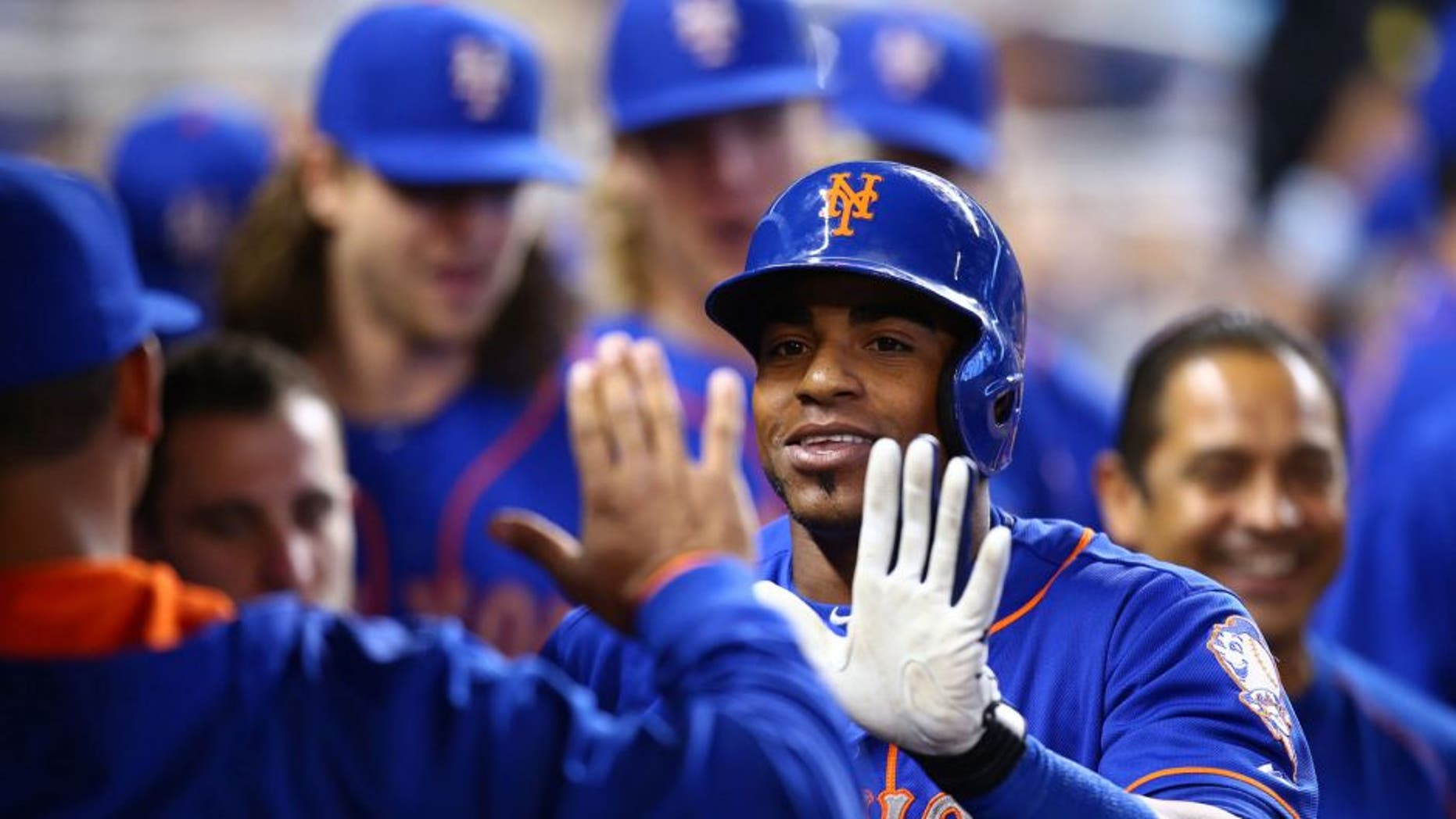 MIAMI, FL - SEPTEMBER 06: Yoenis Cespedes #52 of the New York Mets celebrates with teammates after hitting a solo home run during the first inning of the game against the Miami Marlins at Marlins Park on September 6, 2015 in Miami, Florida. (Photo by Rob Foldy/Getty Images)