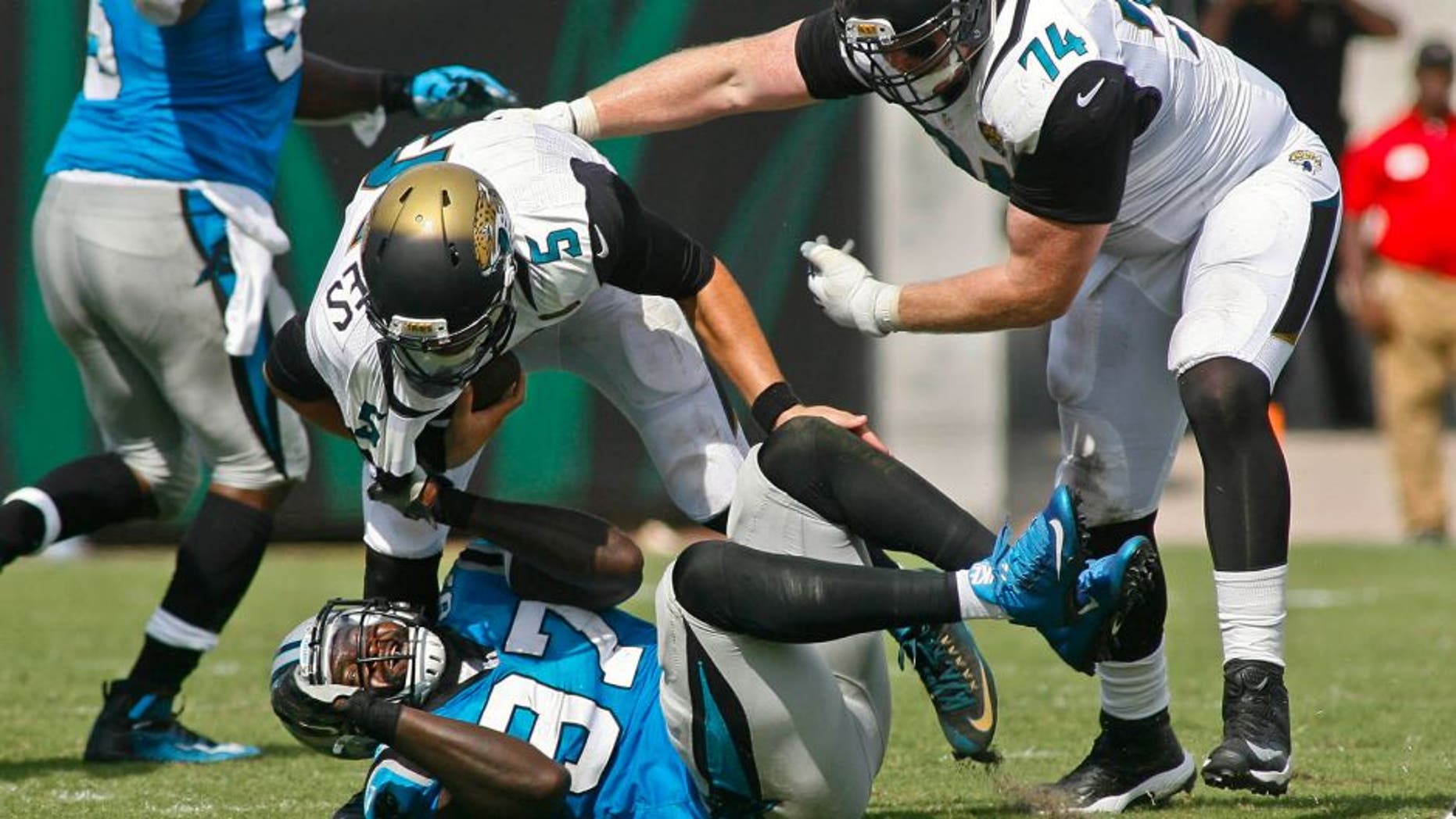 Sep 13, 2015; Jacksonville, FL, USA; Carolina Panthers defensive end Mario Addison (97) drags down Jacksonville Jaguars quarterback Blake Bortles (5) for a sack in the fourth quarter of their game at EverBank Field. The Carolina Panthers won 20-9. Mandatory Credit: Phil Sears-USA TODAY Sports