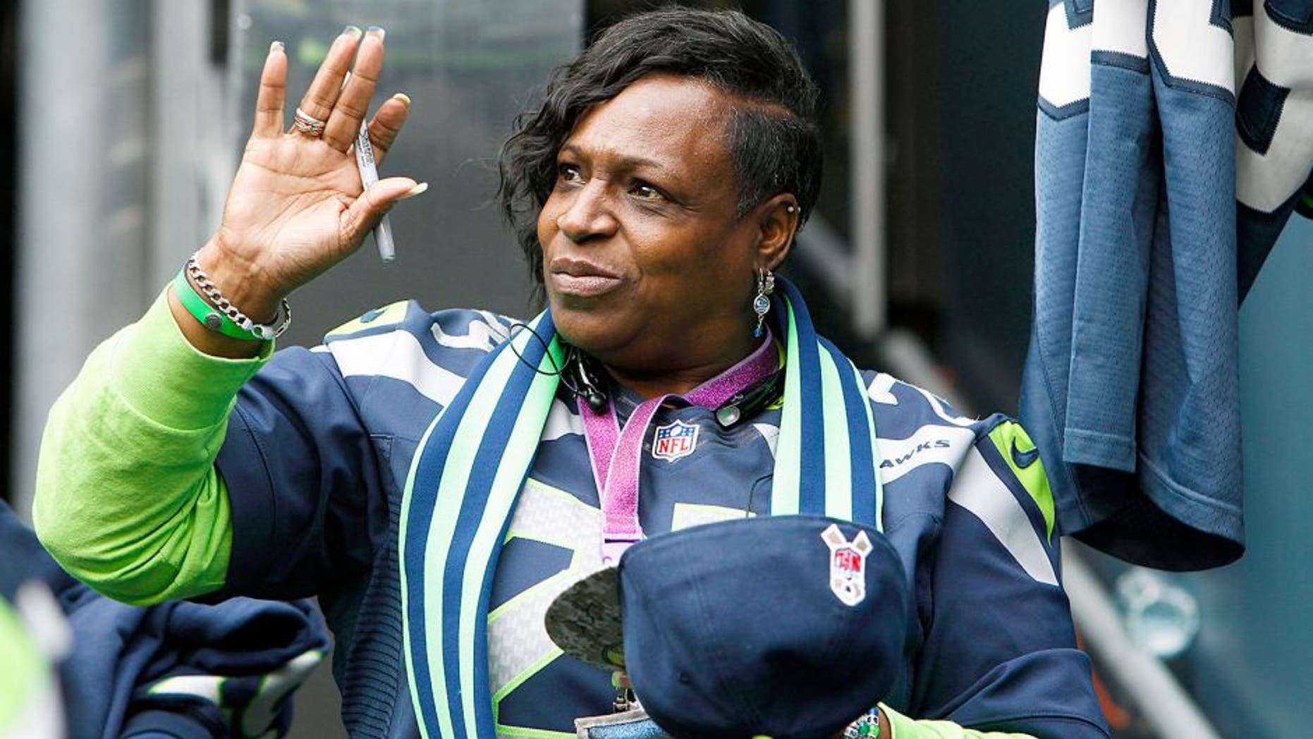 Nov 2, 2014; Seattle, WA, USA; Delisa Lynch waves as she signs autographs during pre game warmups against the Oakland Raiders at CenturyLink Field. Delisa Lynch is the mother of Seattle Seahawks running back Marshawn Lynch (not pictured). Mandatory Credit: Joe Nicholson-USA TODAY Sports
