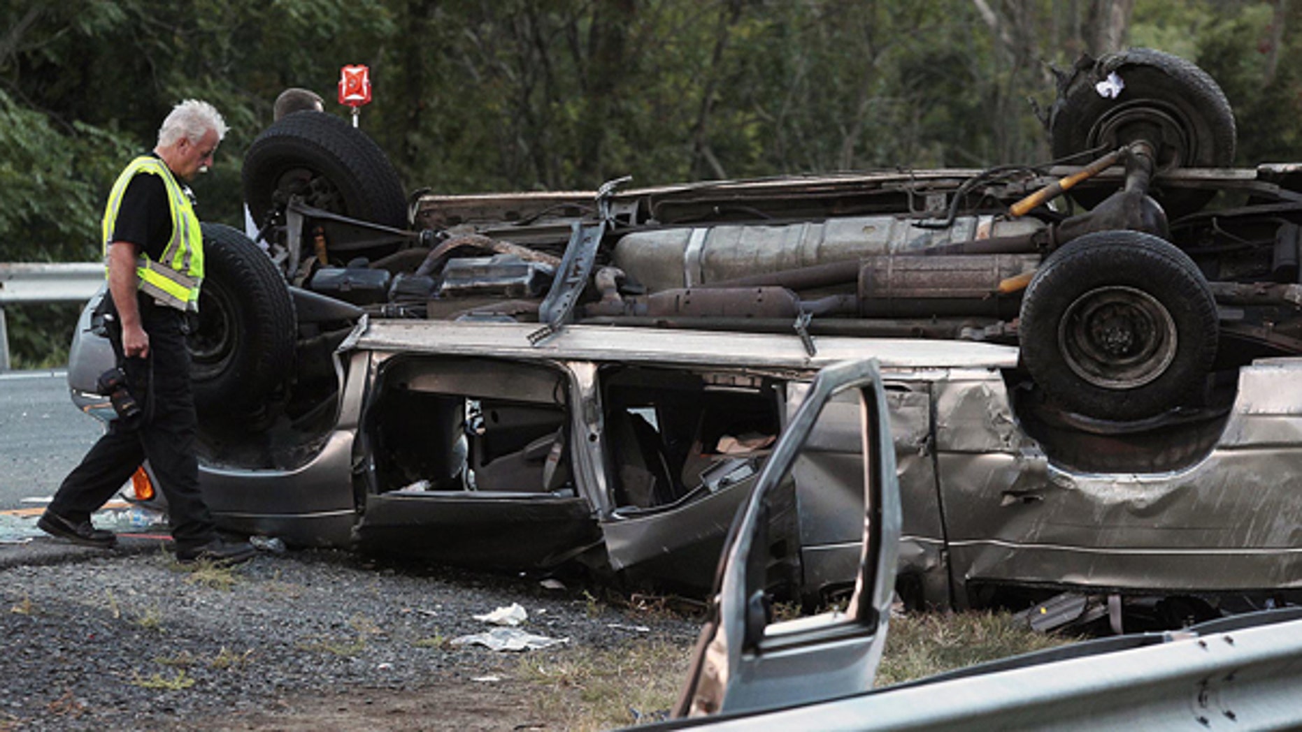 Sept. 18: State police investigate the scene of a fatal accident in Woodbury, N.Y. A passenger van carrying members of a church flipped over killing at least six people and injuring eight others, authorities said.