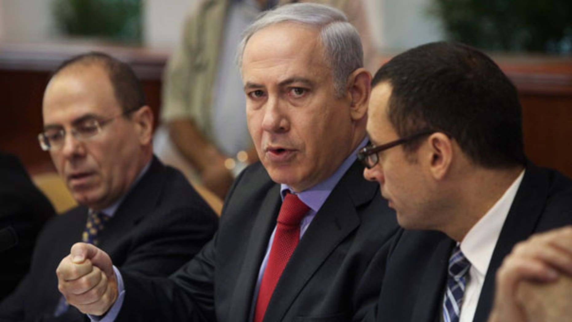 Sept. 18: Israeli Prime Minister Benjamin Netanyahu, center, talks during a weekly cabinet meeting in Jerusalem.