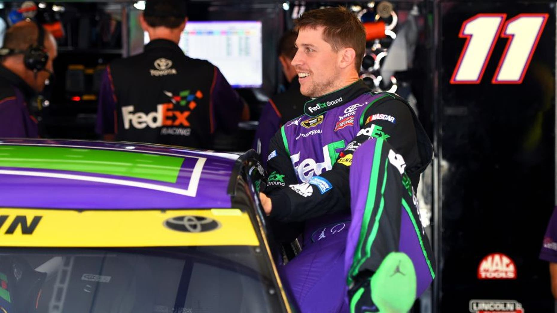 JOLIET, IL - SEPTEMBER 18: Denny Hamlin, driver of the #11 FedEx Ground Toyota, climbs into his car before practice for the NASCAR Sprint Cup Series myAFibRisk.com 400 at Chicagoland Speedway on September 18, 2015 in Joliet, Illinois. (Photo by Josh Hedges/Getty Images)