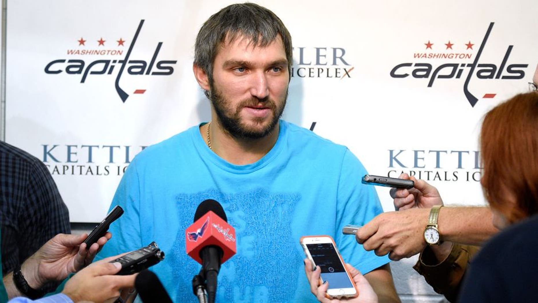 Washington Capitals left wing Alex Ovechkin, of Russia, talks with the press during media day at NHL hockey training camp, Friday, Sept. 18, 2015, in Arlington, Va. (AP Photo/Nick Wass)