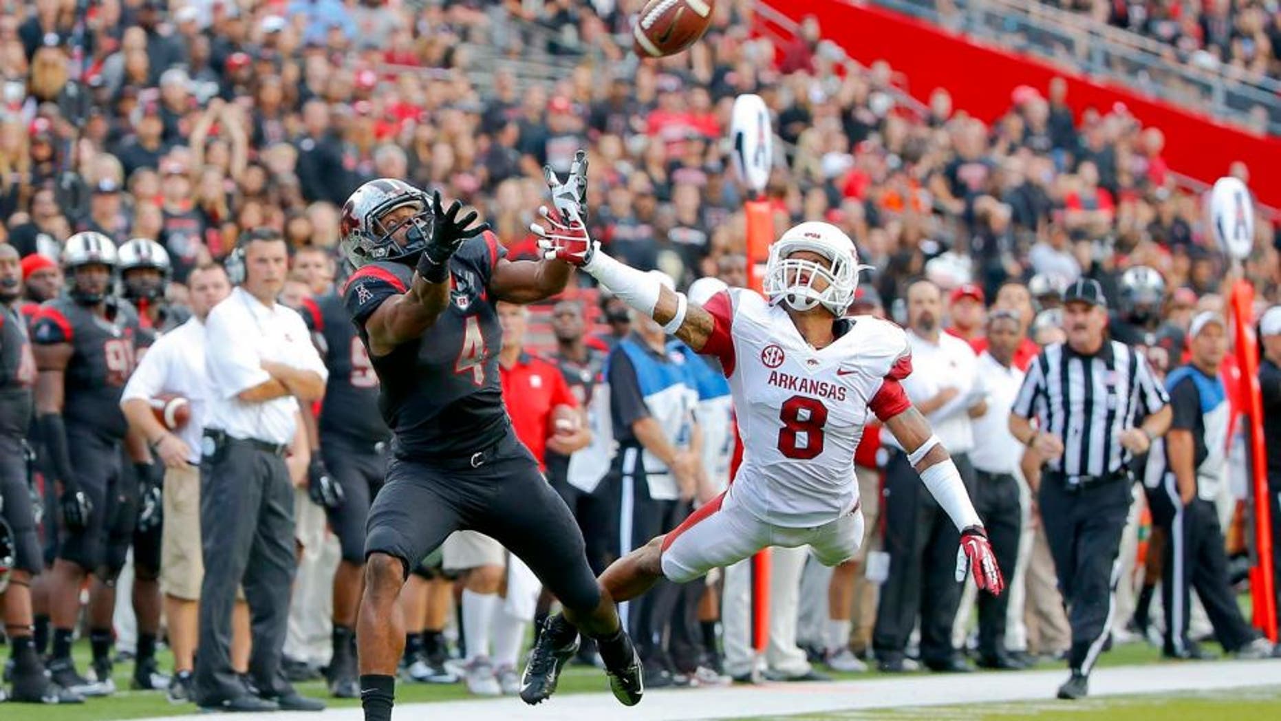 Sep 21, 2013; Piscataway, NJ, USA; Rutgers Scarlet Knights wide receiver Leonte Carroo (4) cannot catch a pass during the second half as he is covered by Arkansas Razorbacks cornerback Tevin Mitchel (8) at High Points Solutions Stadium. Rutgers won 28-24. Mandatory Credit: Jim O'Connor-USA TODAY Sports