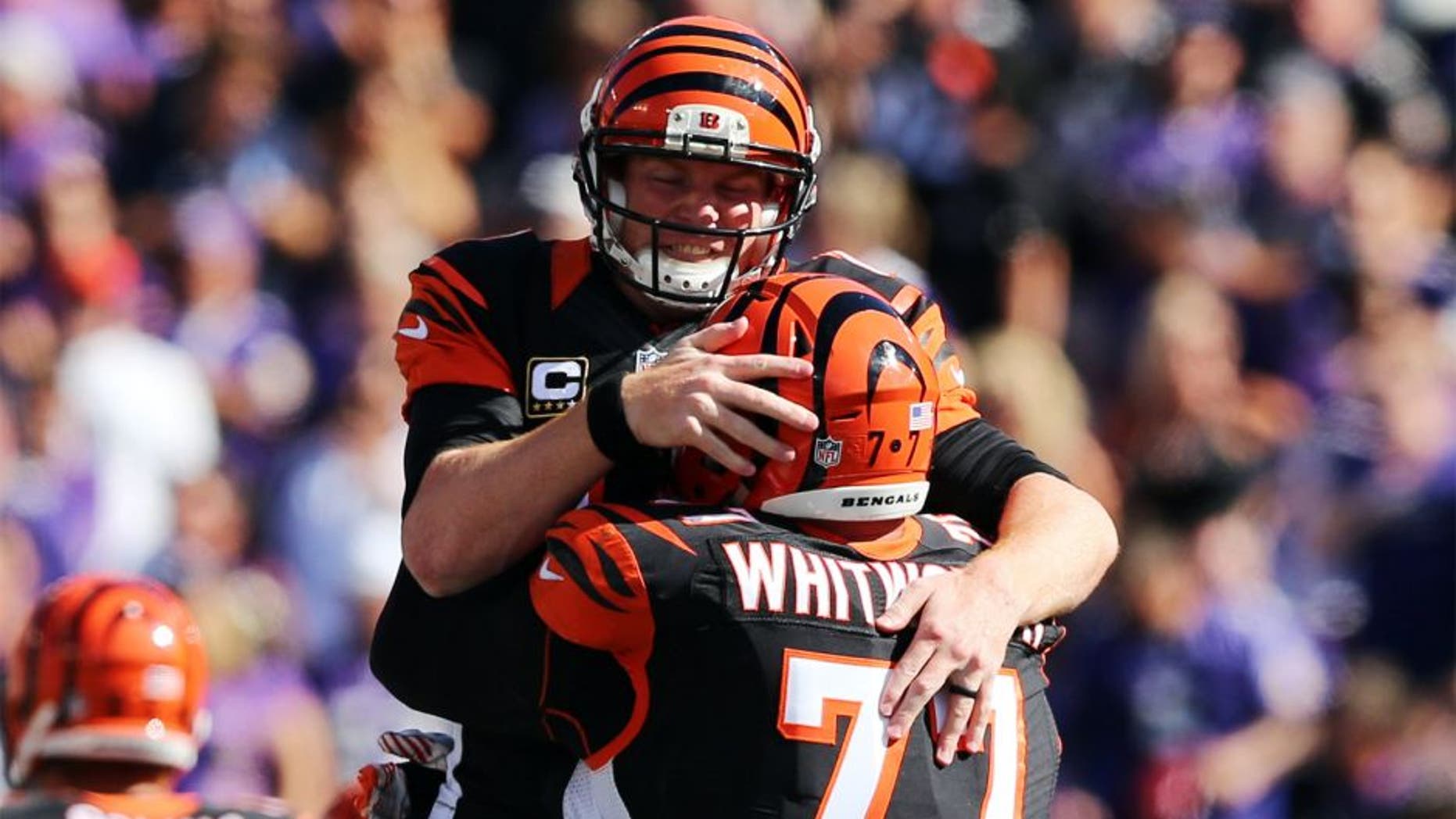 Sep 7, 2014; Baltimore, MD, USA; Cincinnati Bengals quarterback Andy Dalton (14) celebrates his last touchdown pass with tackle Andrew Whitworth (77) against the Baltimore Ravens at M&T Bank Stadium. Mandatory Credit: Mitch Stringer-USA TODAY Sports