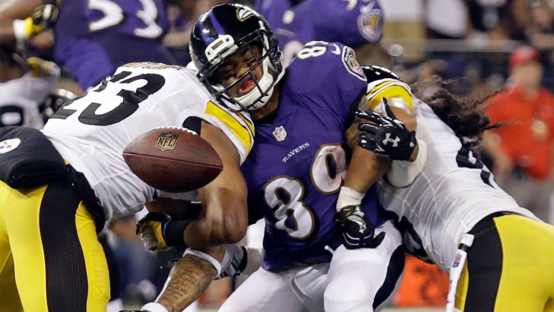 Baltimore Ravens wide receiver Steve Smith (89) can't hang on to a pass as he is hit by Pittsburgh Steelers free safety Mike Mitchell (23) and strong safety Troy Polamalu (43) during the second half of an NFL football game Thursday, Sept. 11, 2014, in Baltimore. (AP Photo/Patrick Semansky)