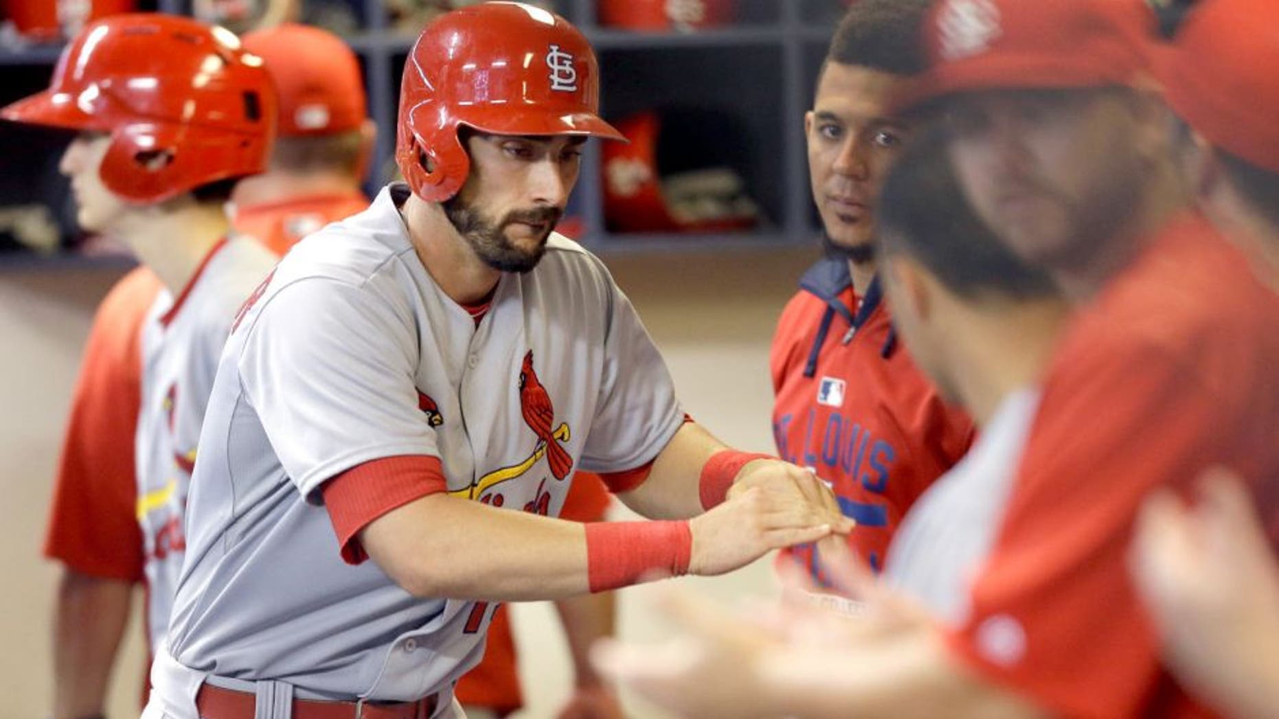 MILWAUKEE, WI - SEPTEMBER 17: Matt Carpenter #13 of the St. Louis Cardinals celebrates in the dugout after hitting a solo home run in the sixth inning against the Milwaukee Brewers at Miller Park on September 17, 2015 in Milwaukee, Wisconsin. (Photo by Mike McGinnis/Getty Images)
