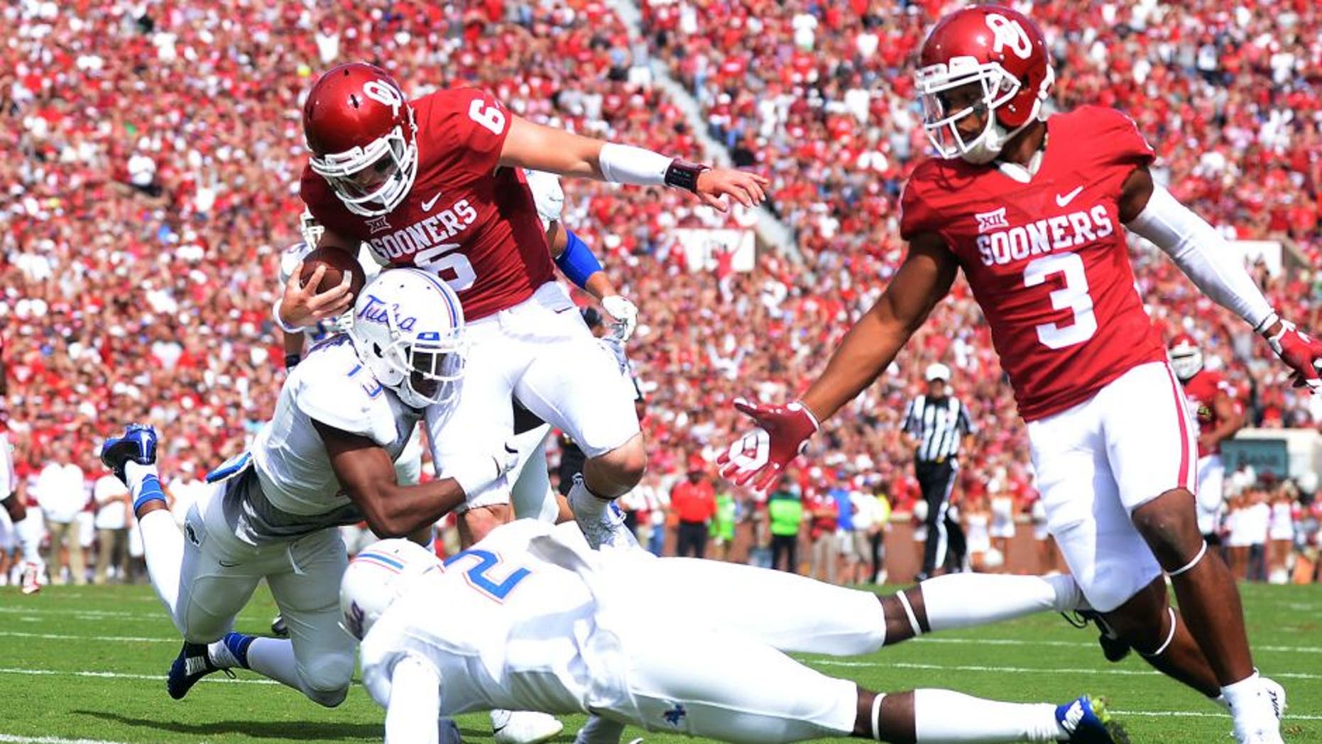 Sep 19, 2015; Norman, OK, USA;Oklahoma Sooners quarterback Baker Mayfield (6) runs for a touchdown against the Tulsa Golden Hurricane during the first quarter at Gaylord Family - Oklahoma Memorial Stadium. Mandatory Credit: Mark D. Smith-USA TODAY Sports