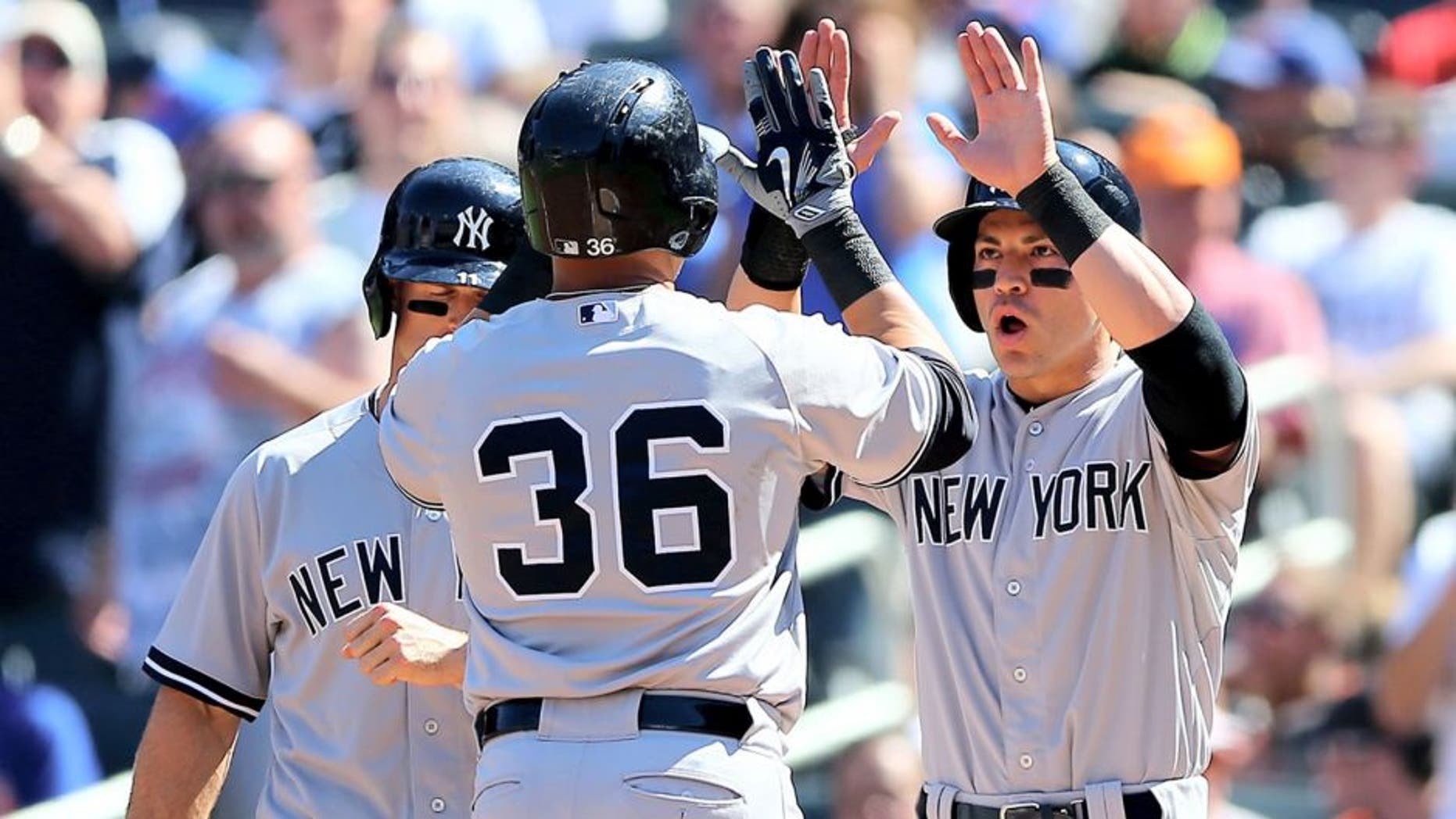 NEW YORK, NY - SEPTEMBER 19: Jacoby Ellsbury #22 and Brett Gardner #11 of the New York Yankees celebrate with Carlos Beltran #36 after Beltran drove them all in with a home run in the first inning against the New York Mets during interleague play on September 19, 2015 at Citi Field in the Flushing neighborhood of the Queens borough of New York City. (Photo by Elsa/Getty Images)