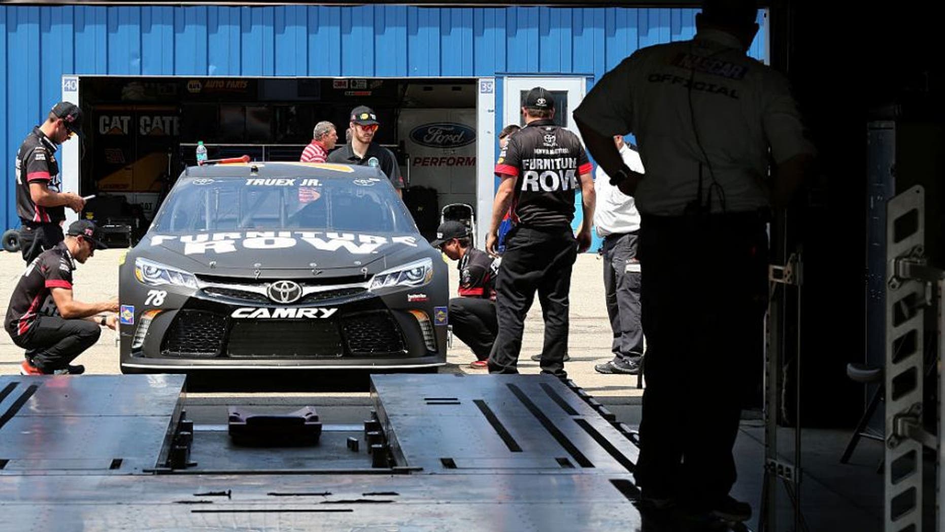 BROOKLYN, MI - JUNE 10: NASCAR officials inspect the #78 Furniture Row Toyota driven by Martin Truex Jr. (not pictured) prior to qualifying for the NASCAR Sprint Cup Series FireKeepers Casino 400 at Michigan International Speedway on June 10, 2016 in Brooklyn, Michigan. (Photo by Jerry Markland/Getty Images )