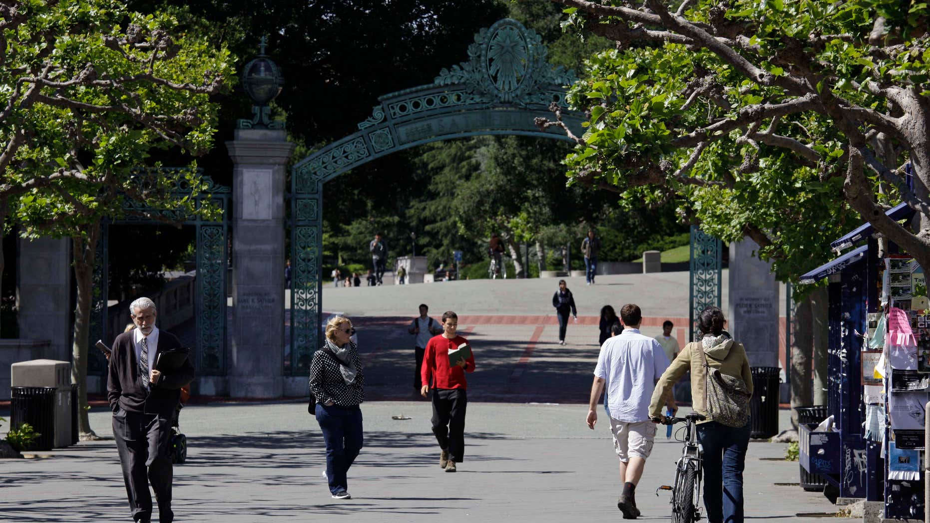 FILE - In this June 1, 2011, file photo, people walk through Sproul Plaza near the Sather Gate on the University of California, Berkeley campus in Berkeley, Calif.