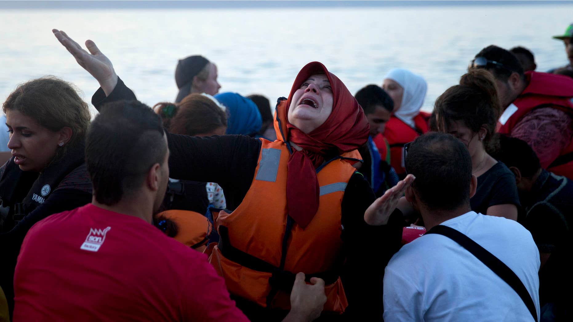 Sept. 19, 2015: A woman reacts as she arrives aboard a dinghy after crossing from Turkey, to the island of Lesbos, Greece