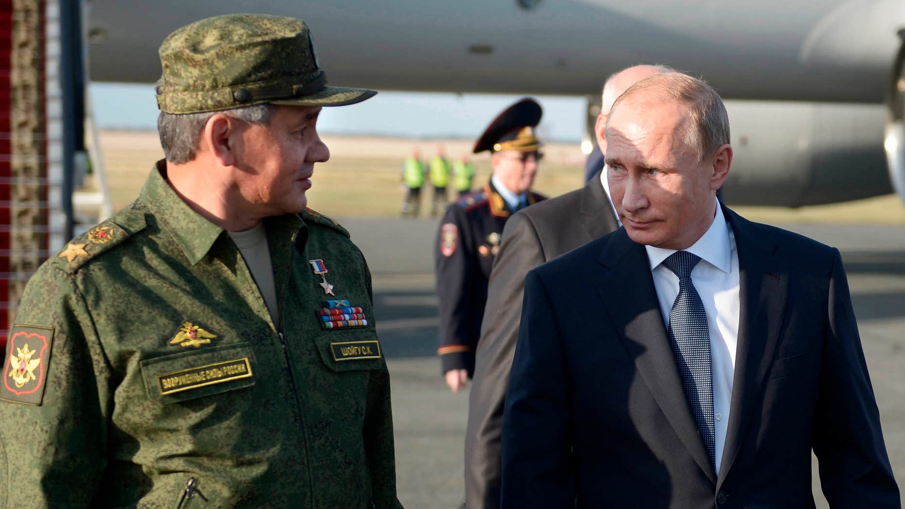 Sept. 19, 2015: Russian President Vladimir Putin speaks with Defense Minister Sergei Shoigu on his arrival in Orenburg region, about 800 miles southeast of Moscow, Russia.