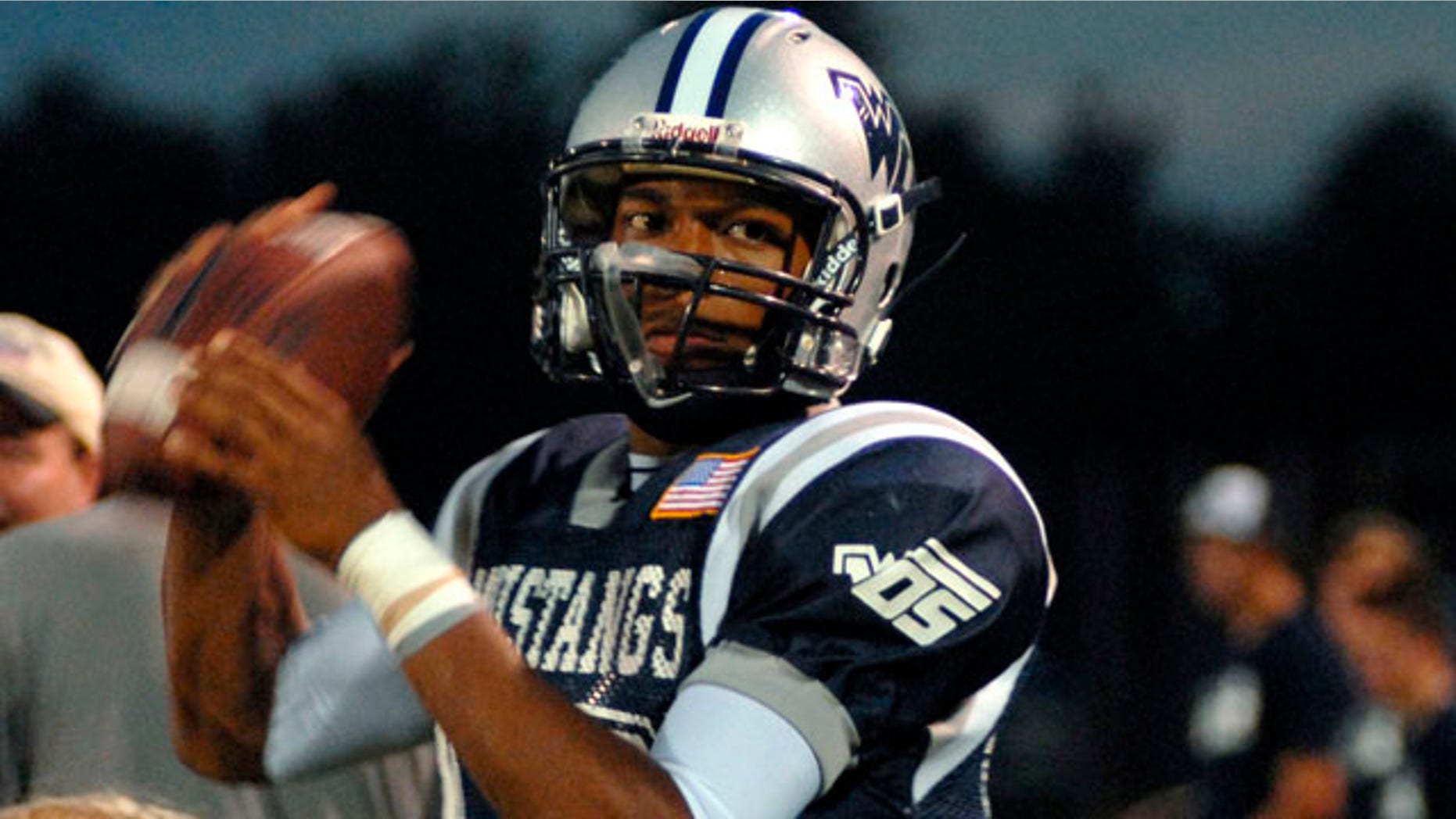 In this Friday, Sept. 17, 2010, photo, West Orange-Stark quarterback Reggie Garrett Jr. warms up for a football game against Jasper in Beaumont, Texas. Garrett collapsed on the sidelines shortly after throwing a touchdown pass in the game, and later died. A cause of death hasn't been determined. (AP Photo/The Beaumont Enterprise, Beth Rankin)