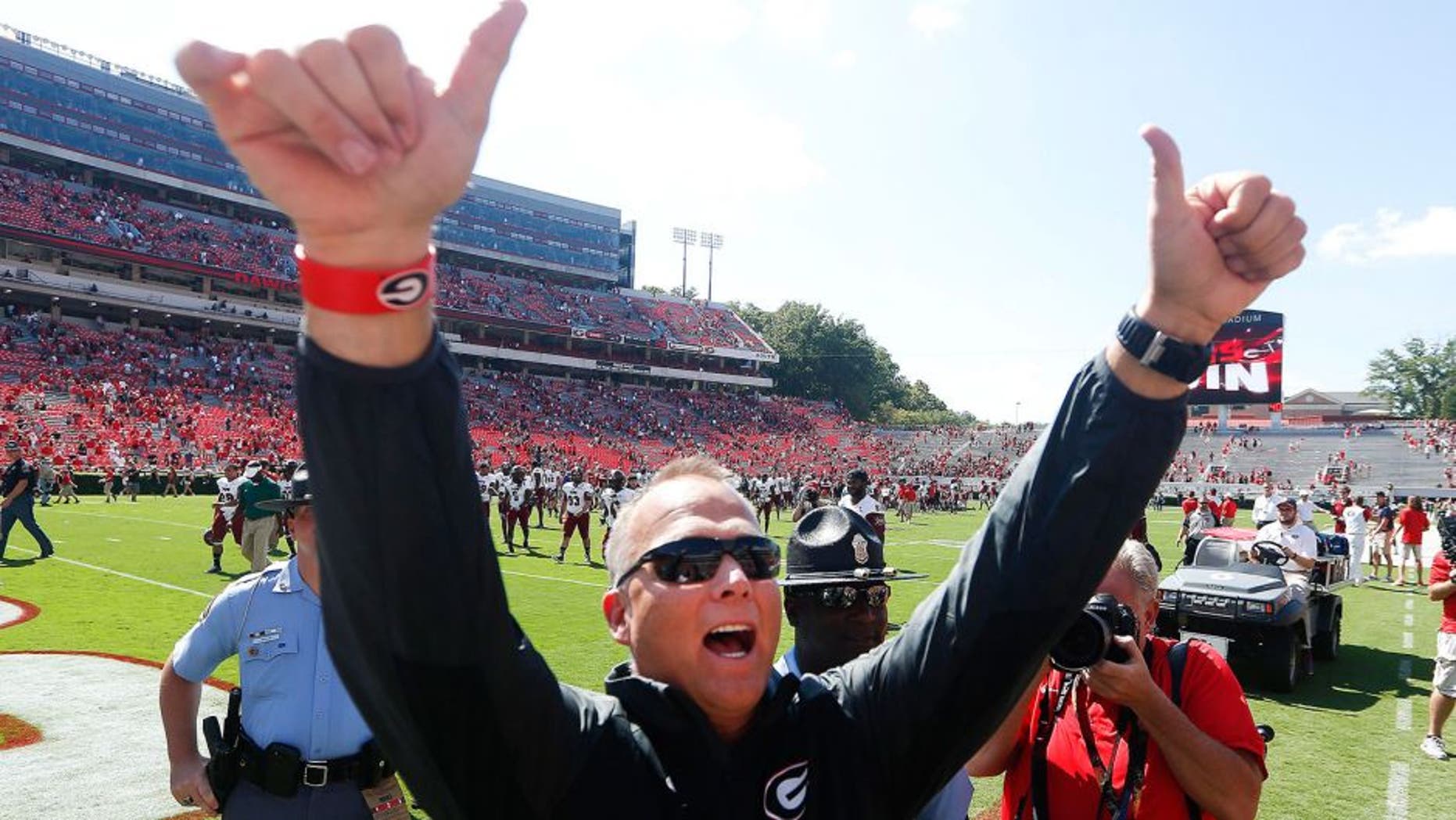 Georgia head coach Mark Richt gestures toward the crowd after defeating Troy 66-0 in an NCAA college football game, Saturday, Sept. 20, 2014, in Athens, Ga. (AP Photo/John Bazemore)