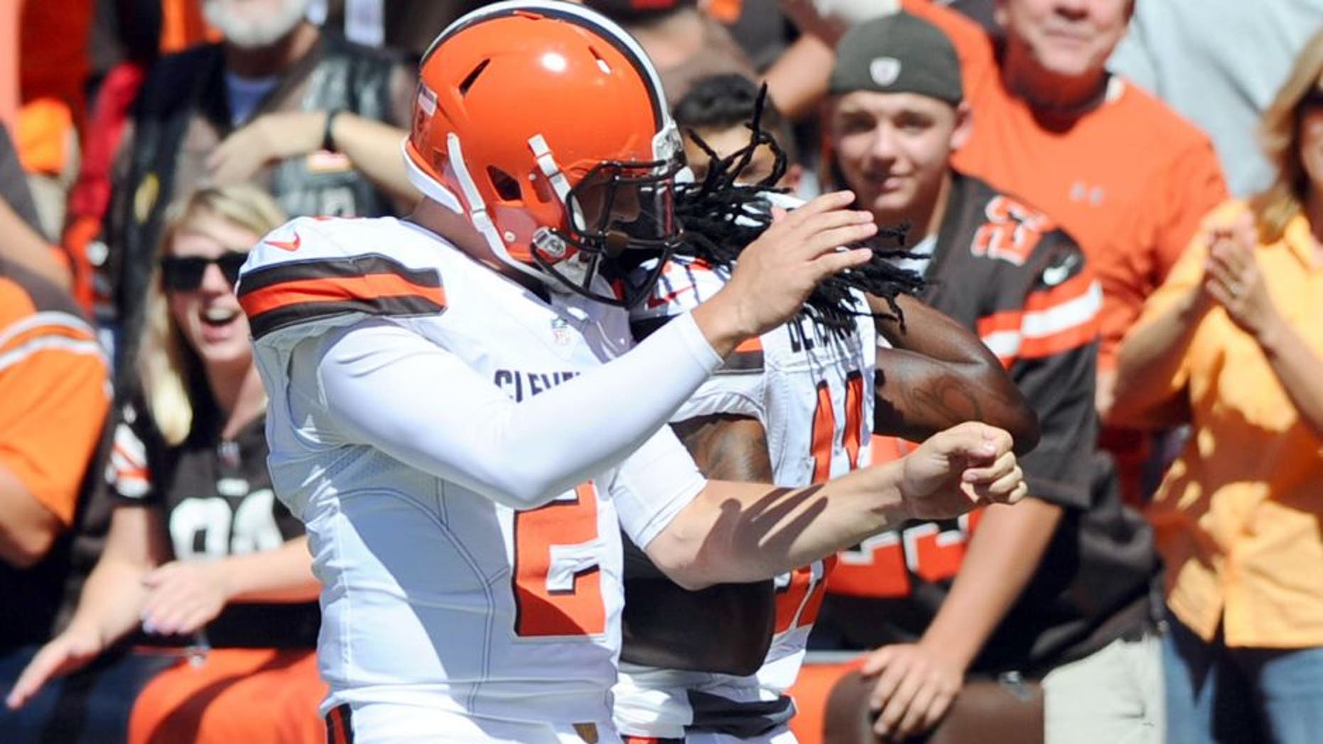 Sep 20, 2015; Cleveland, OH, USA; Cleveland Browns quarterback Johnny Manziel (2) and wide receiver Travis Benjamin (11) celebrate a first quarter touchdown pass against the Tennessee Titans at FirstEnergy Stadium. Mandatory Credit: Ken Blaze-USA TODAY Sports