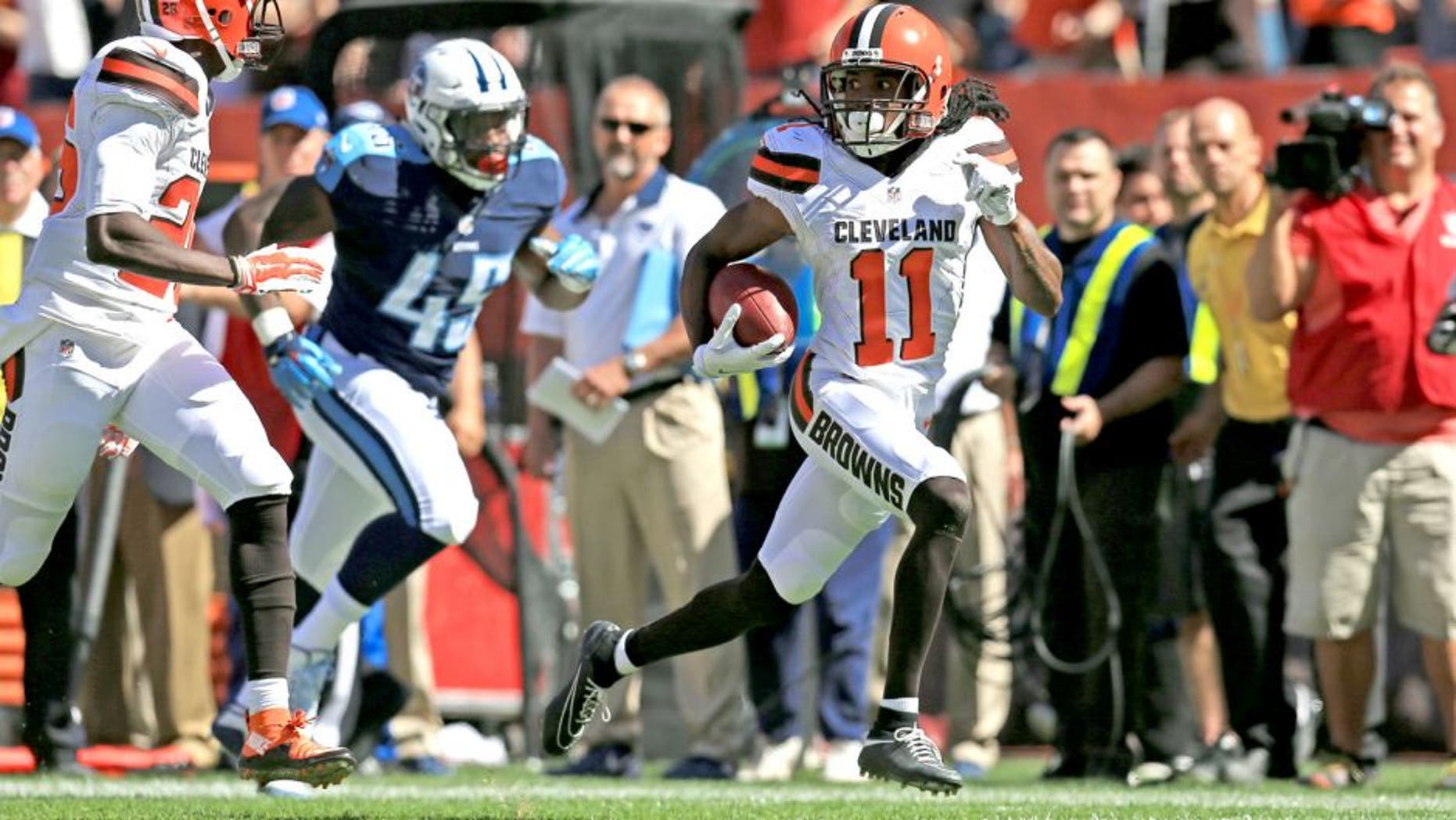 Sep 20, 2015; Cleveland, OH, USA; Cleveland Browns wide receiver Travis Benjamin (11) returns for a punt for a touchdown during the second quarter against the Tennessee Titans at FirstEnergy Stadium. Mandatory Credit: Andrew Weber-USA TODAY Sports
