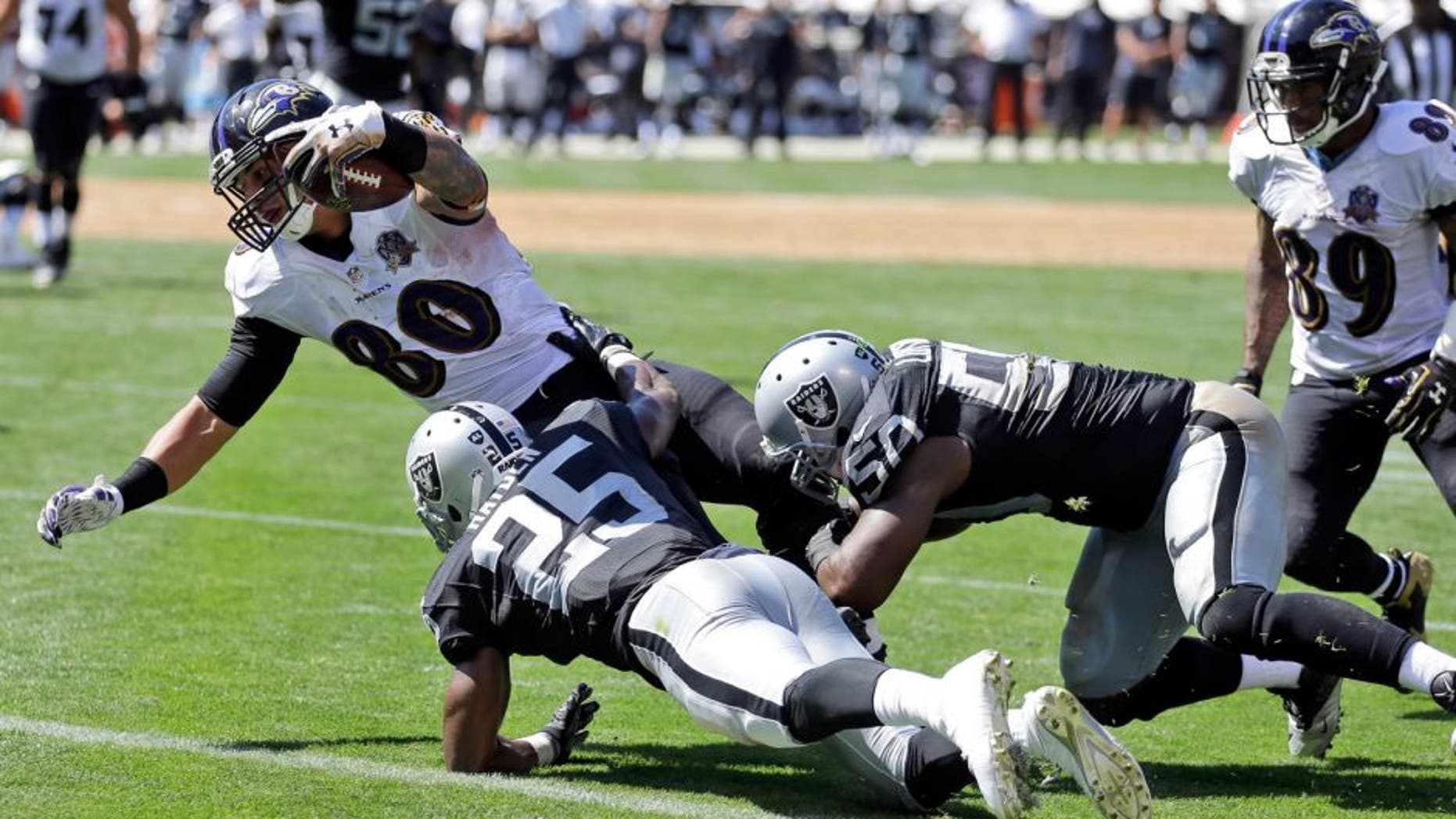 Baltimore Ravens' Crockett Gillmore (80) scores on a 9-yard reception during an NFL football game against the Oakland Raiders, Sunday, Sept. 20, 2015, in Oakland , Calif. (AP Photo/Ben Margot)