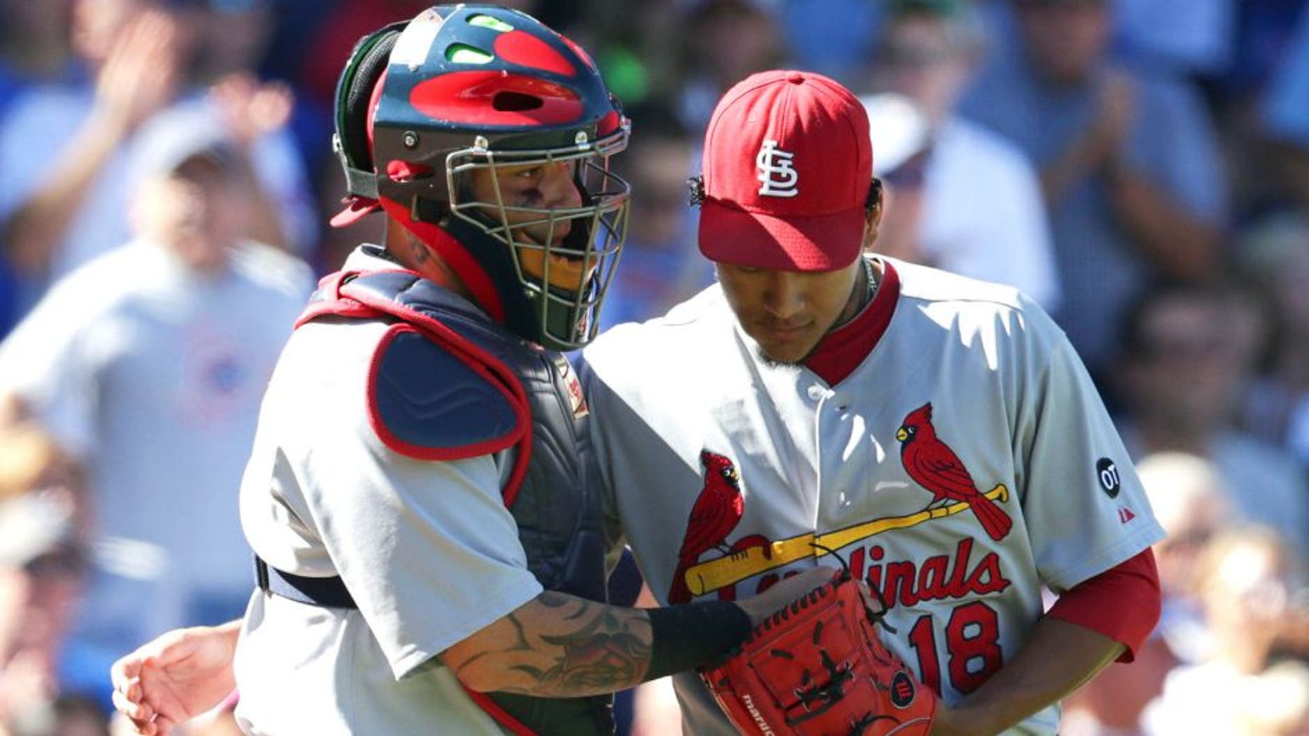CHICAGO, IL - SEPTEMBER 20: Carlos Martinez #18 of the St. Louis Cardinals talks with catcher Yadier Molina #4 of the St. Louis Cardinals during the third inning at Wrigley Field on September 20, 2015 in Chicago, Illinois. The Cardinals defeated the Cubs 4-3. (Photo by John Konstantaras/Getty Images)