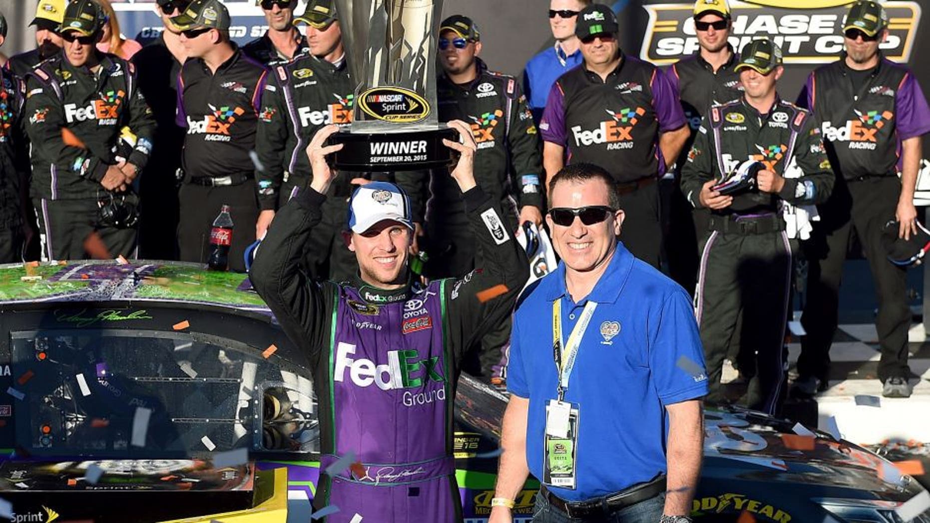JOLIET, IL - SEPTEMBER 20: Denny Hamlin, driver of the #11 FedEx Ground Toyota, celebrates in Victory Lane after winning the NASCAR Sprint Cup Series myAFibRisk.com 400 at Chicagoland Speedway on September 20, 2015 in Joliet, Illinois. (Photo by Josh Hedges/Getty Images)