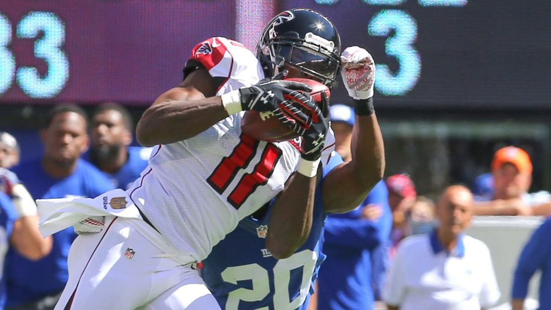 Sep 20, 2015; East Rutherford, NJ, USA; Atlanta Falcons wide receiver Julio Jones (11) catches a pass while being defended by New York Giants cornerback Prince Amukamara (20) during the first half at MetLife Stadium. Mandatory Credit: Ed Mulholland-USA TODAY Sports