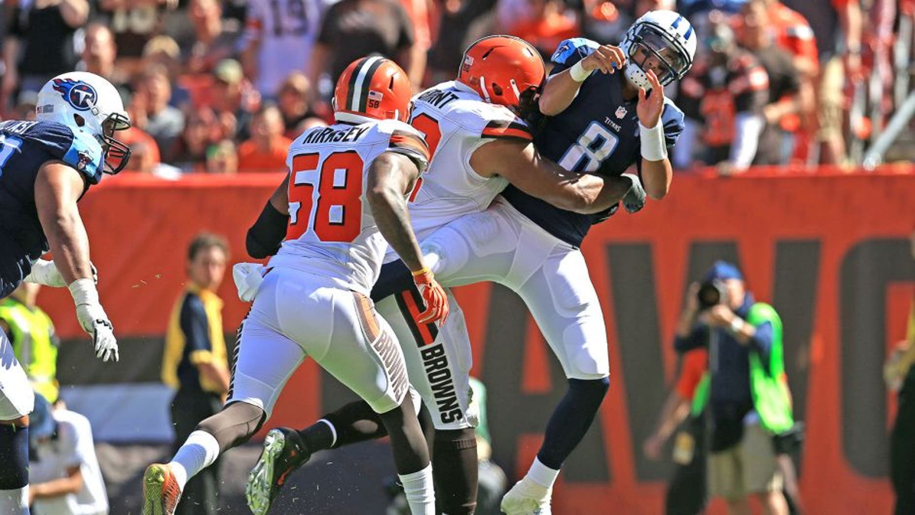 Sep 20, 2015; Cleveland, OH, USA; Tennessee Titans quarterback Marcus Mariota (8) is hit in the backfield by Cleveland Browns defensive end Desmond Bryant (92) during the third quarter at FirstEnergy Stadium. Mandatory Credit: Andrew Weber-USA TODAY Sports