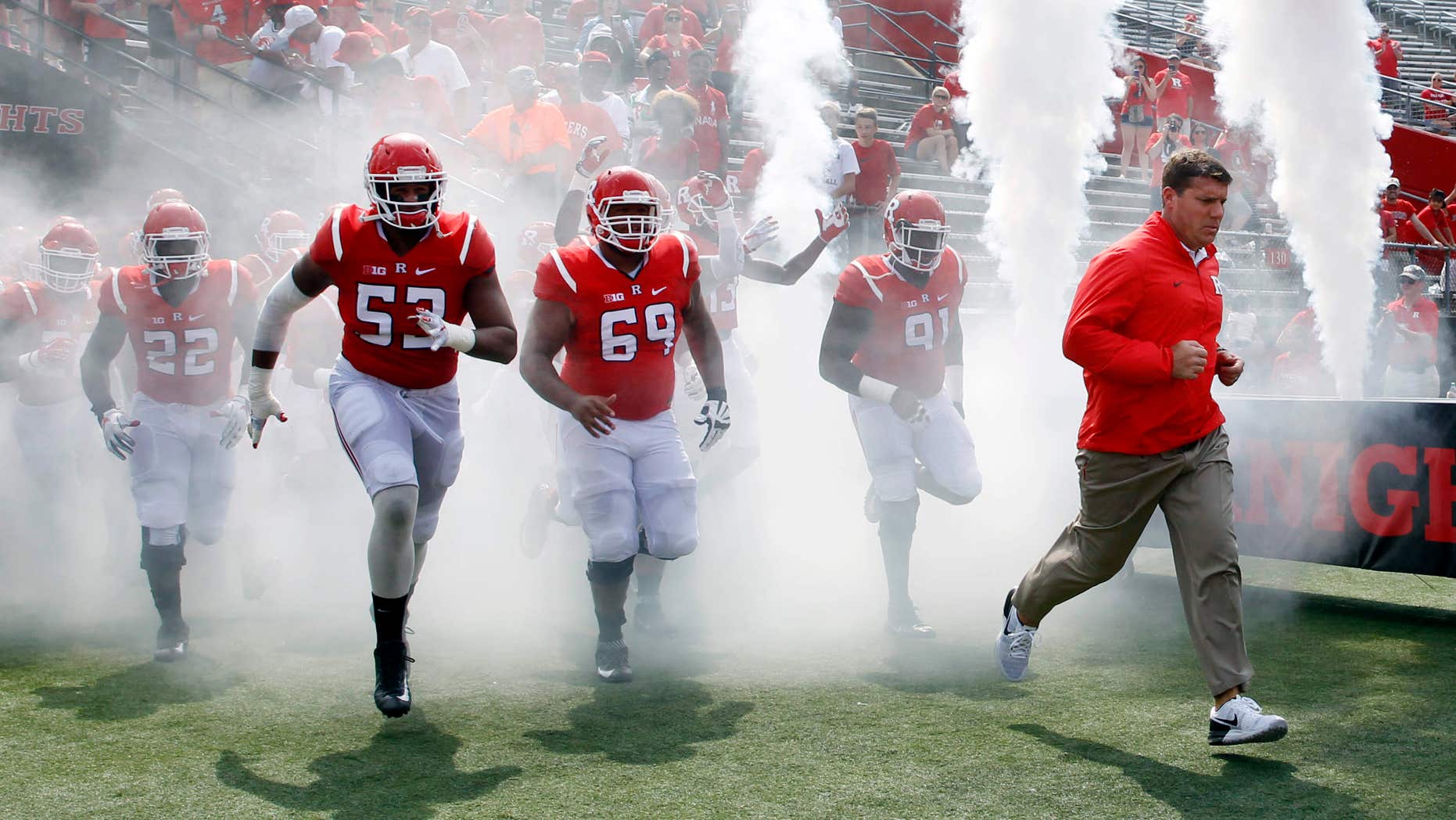 Rutgers coach Chris Ash, right, leads his players onto the field before a NCAA college football game against Howard Saturday, Sept. 10, 2016, in Piscataway, N.J.