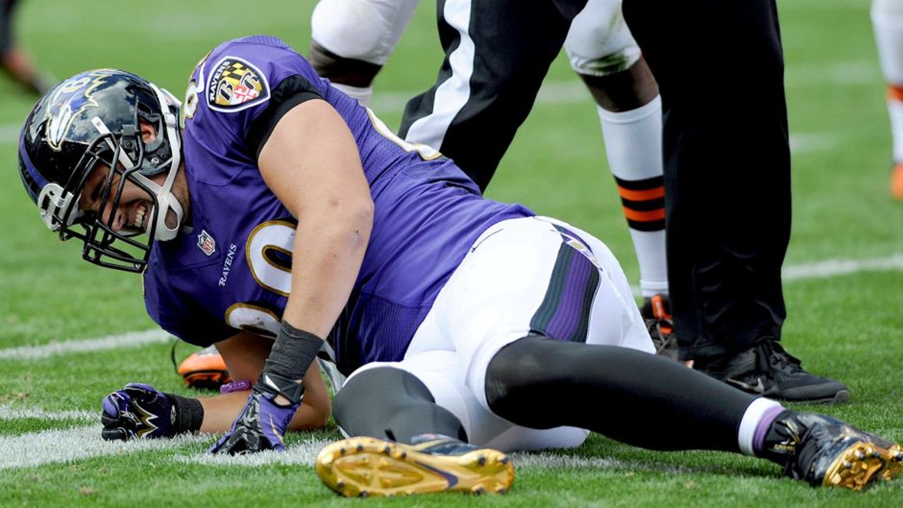Sep 21, 2014; Cleveland, OH, USA; Baltimore Ravens tight end Dennis Pitta (88) winces in pain after getting injured during the second quarter against the Cleveland Browns at FirstEnergy Stadium. Mandatory Credit: Ken Blaze-USA TODAY Sports